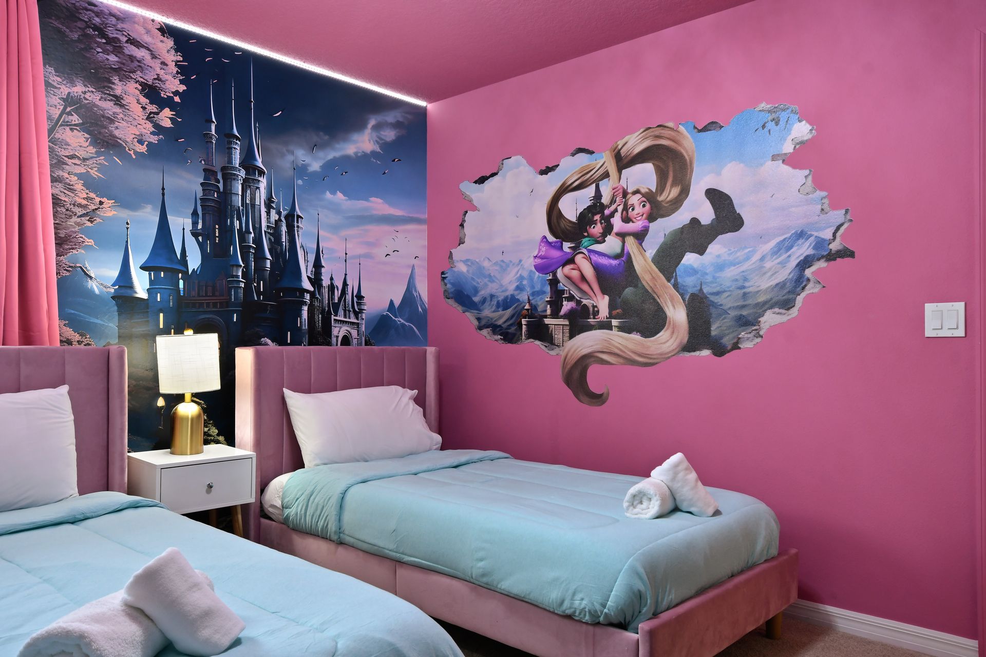 Whimsical princess room with castle mural, twin beds, and magical pink charm.
