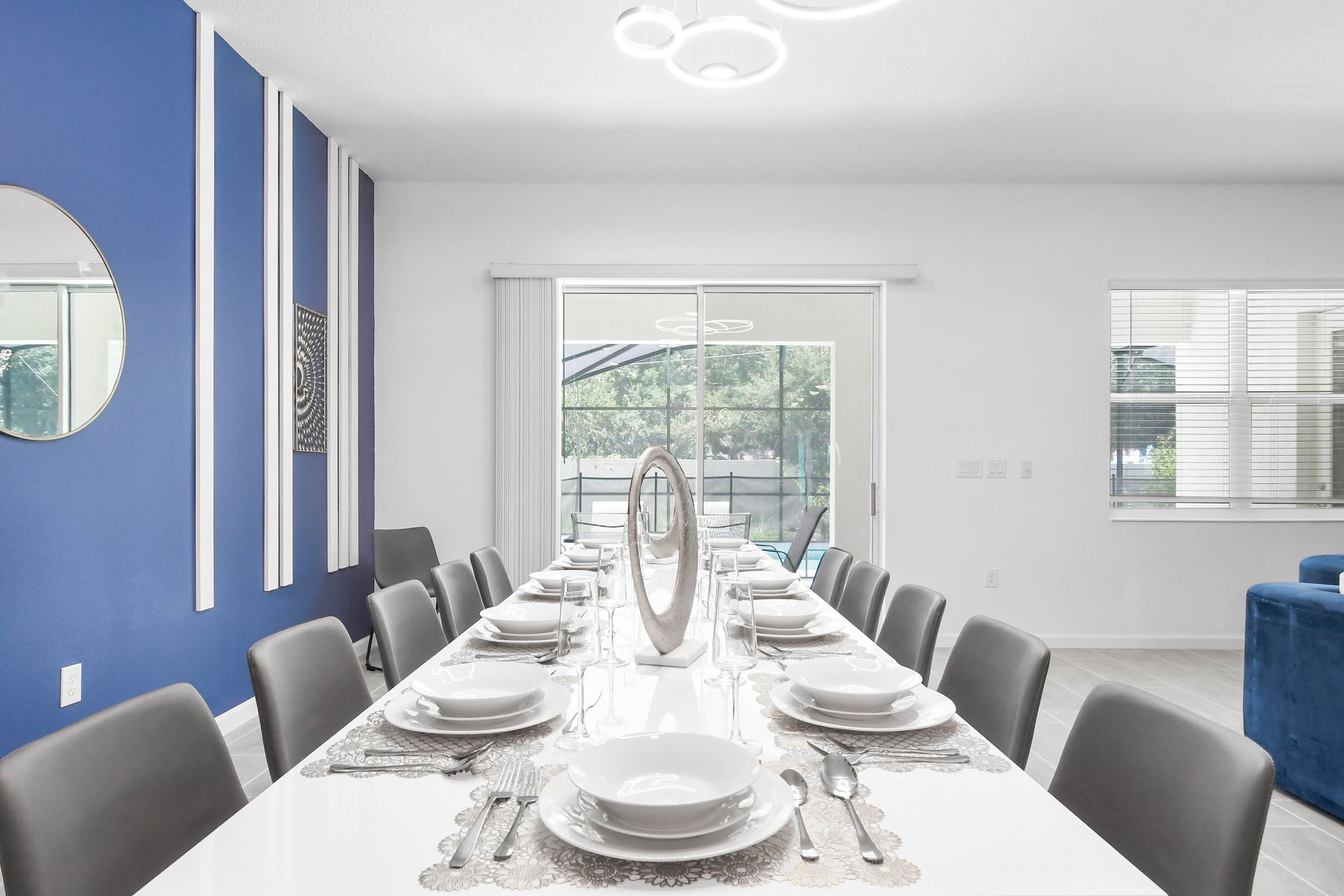 Elegant dining space with modern décor, seating for ten, and a view of the pool.