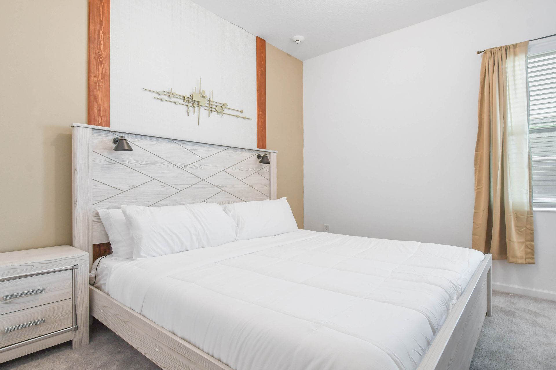 Cozy rustic-modern bedroom with a plush king bed, warm tones, and stylish décor.