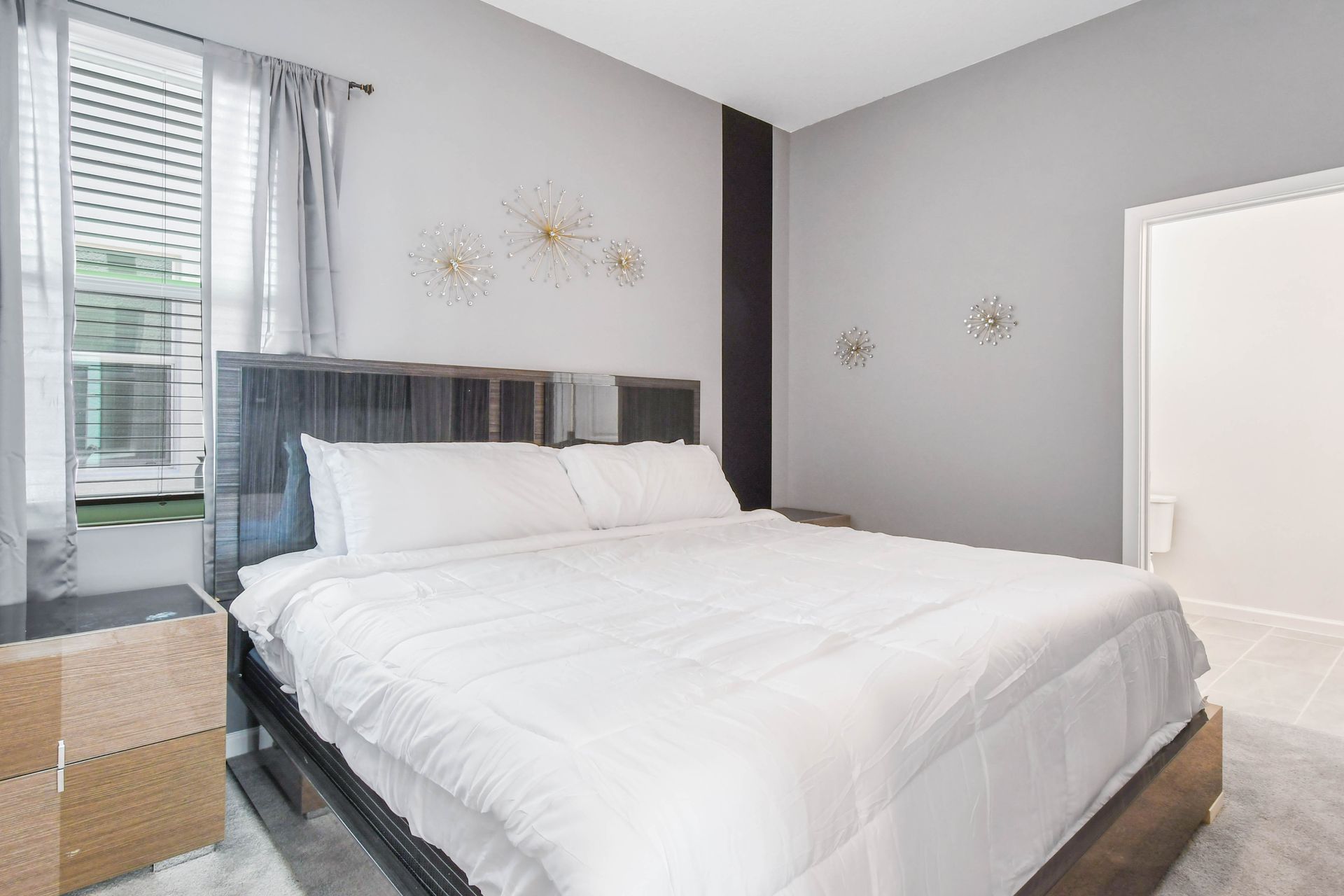 Stylish and serene bedroom with a plush king bed, modern décor, and private bathroom.