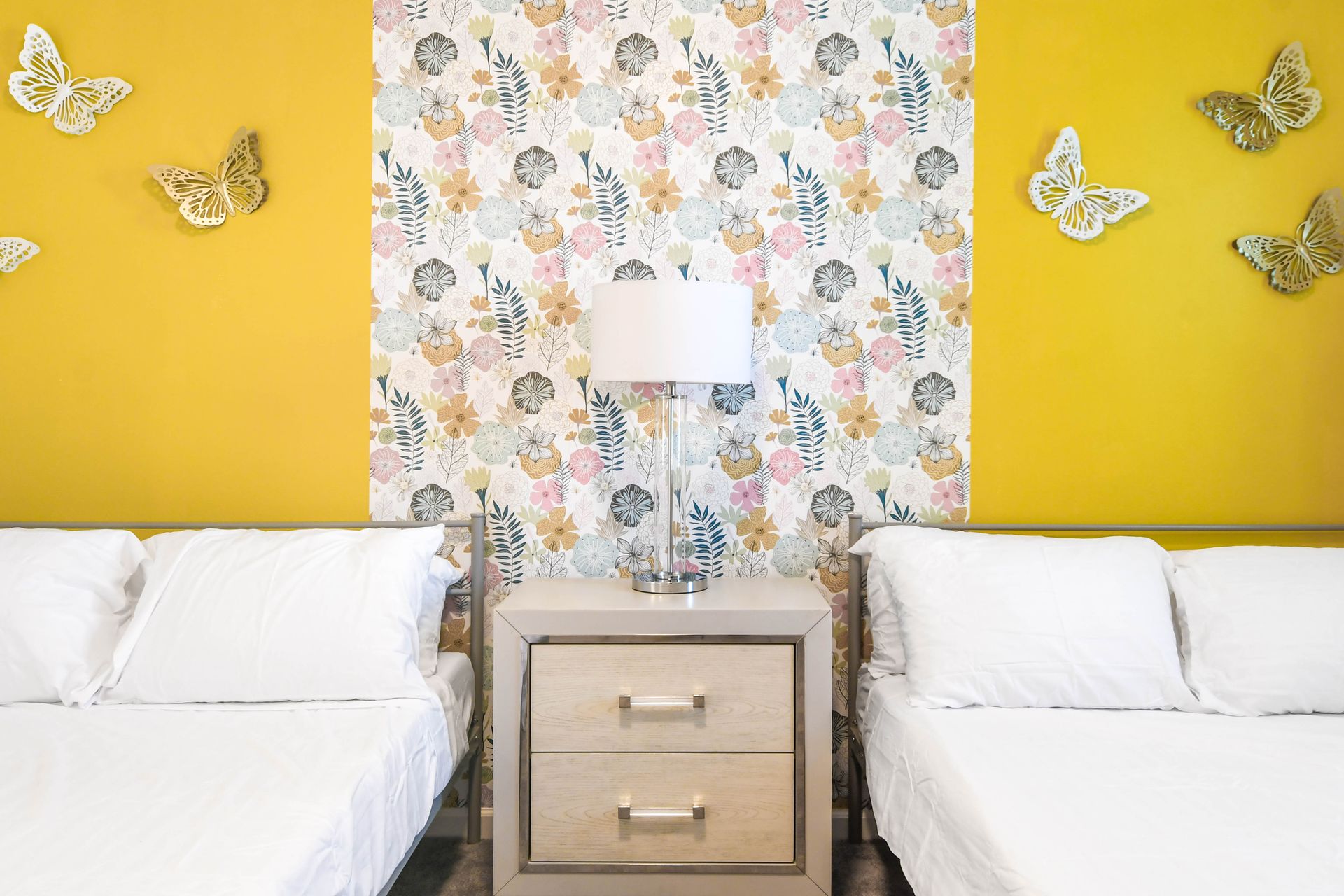 Vibrant bedroom with floral accents, golden tones, and charming butterfly décor.