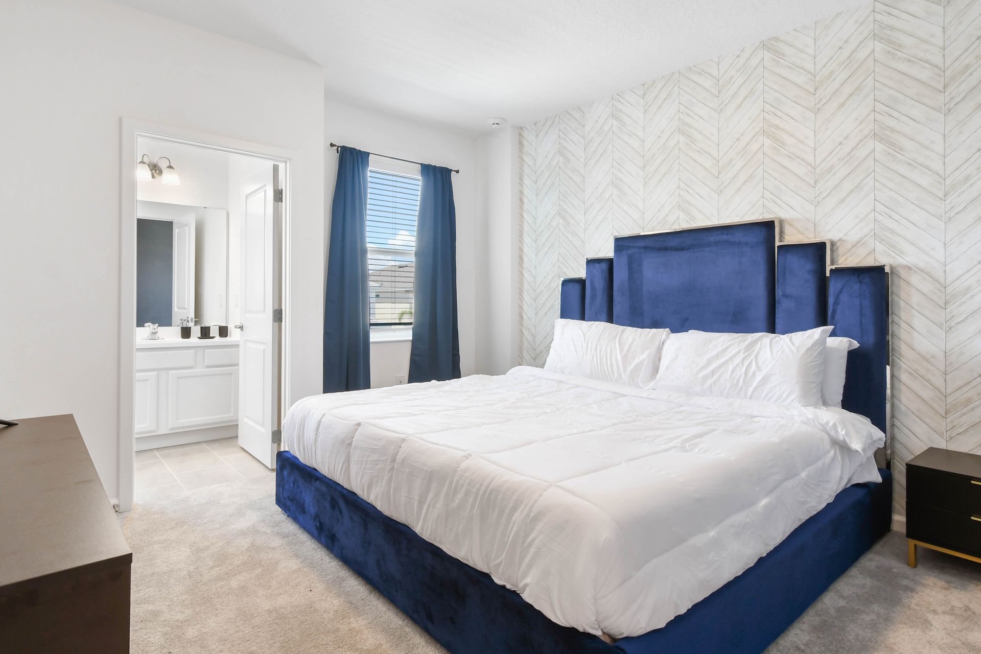 Sophisticated bedroom with a plush king bed, stylish décor, and a private bathroom.