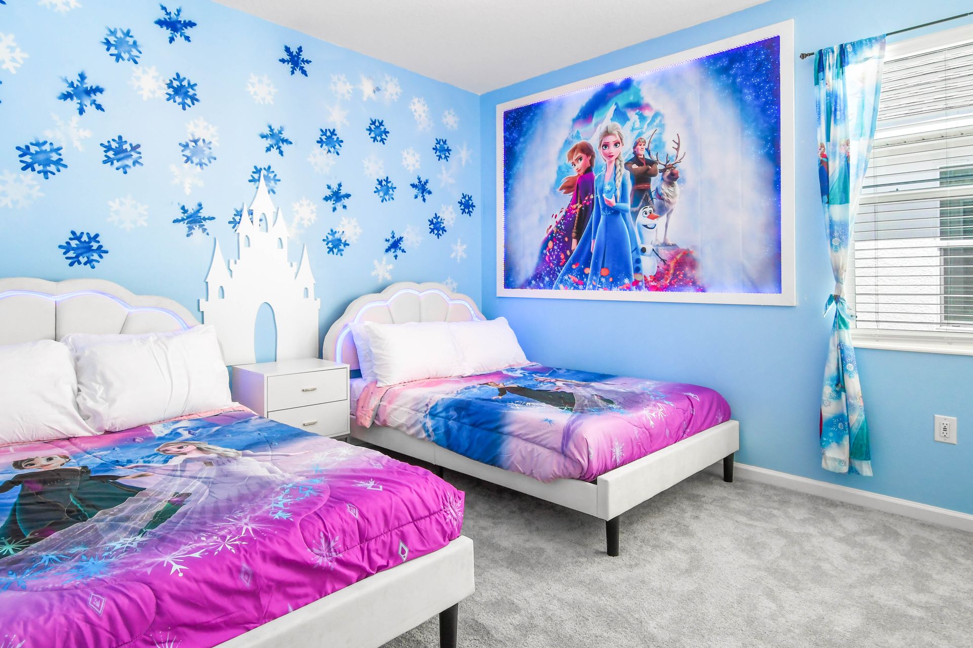 Magical winter-themed bedroom with glowing beds, snowflake décor, and cozy charm.