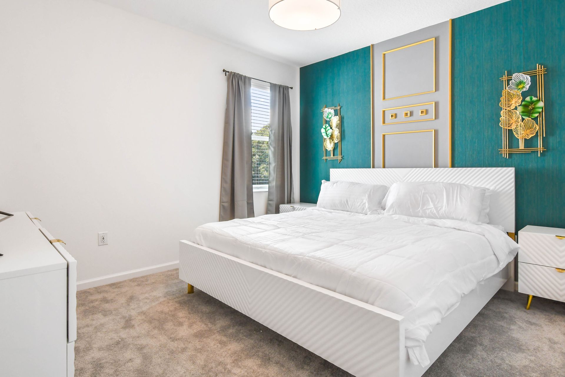 Stylish bedroom with elegant gold accents, a plush king bed, and a smart TV.