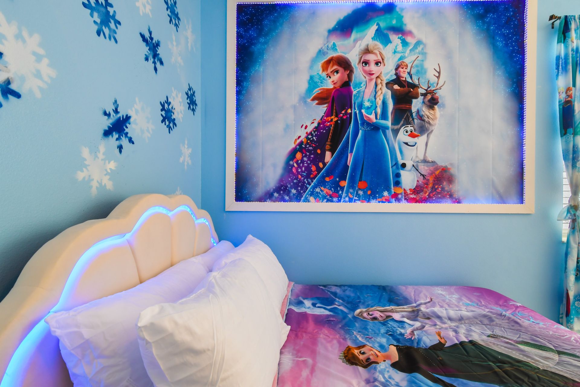 Enchanting winter-themed bedroom with glowing headboards and magical snowy décor.