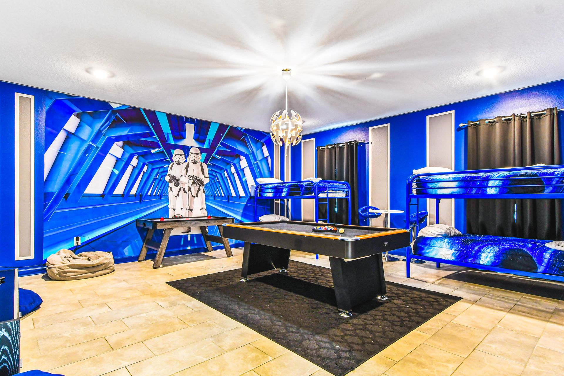 Step into another galaxy! Star Wars-inspired bunk room with games & cosmic décor!