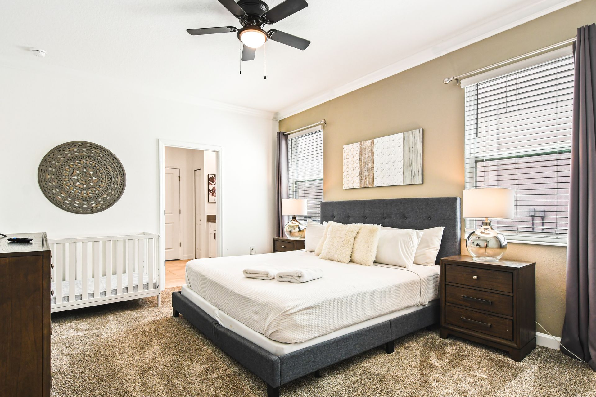 Cozy and welcoming bedroom with a soft, neutral palette, featuring a plush bed.