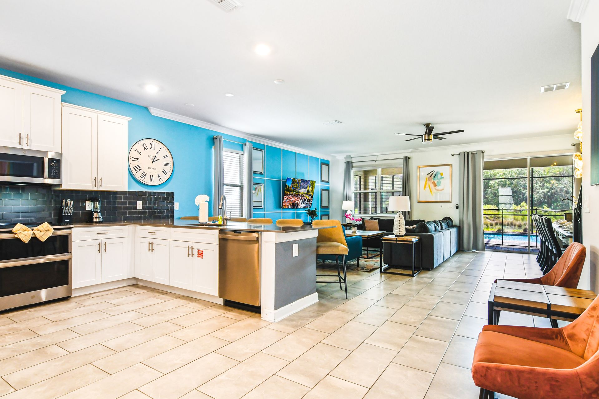 Bright, modern open-concept living! Fully equipped kitchen, cozy seating, pool view.