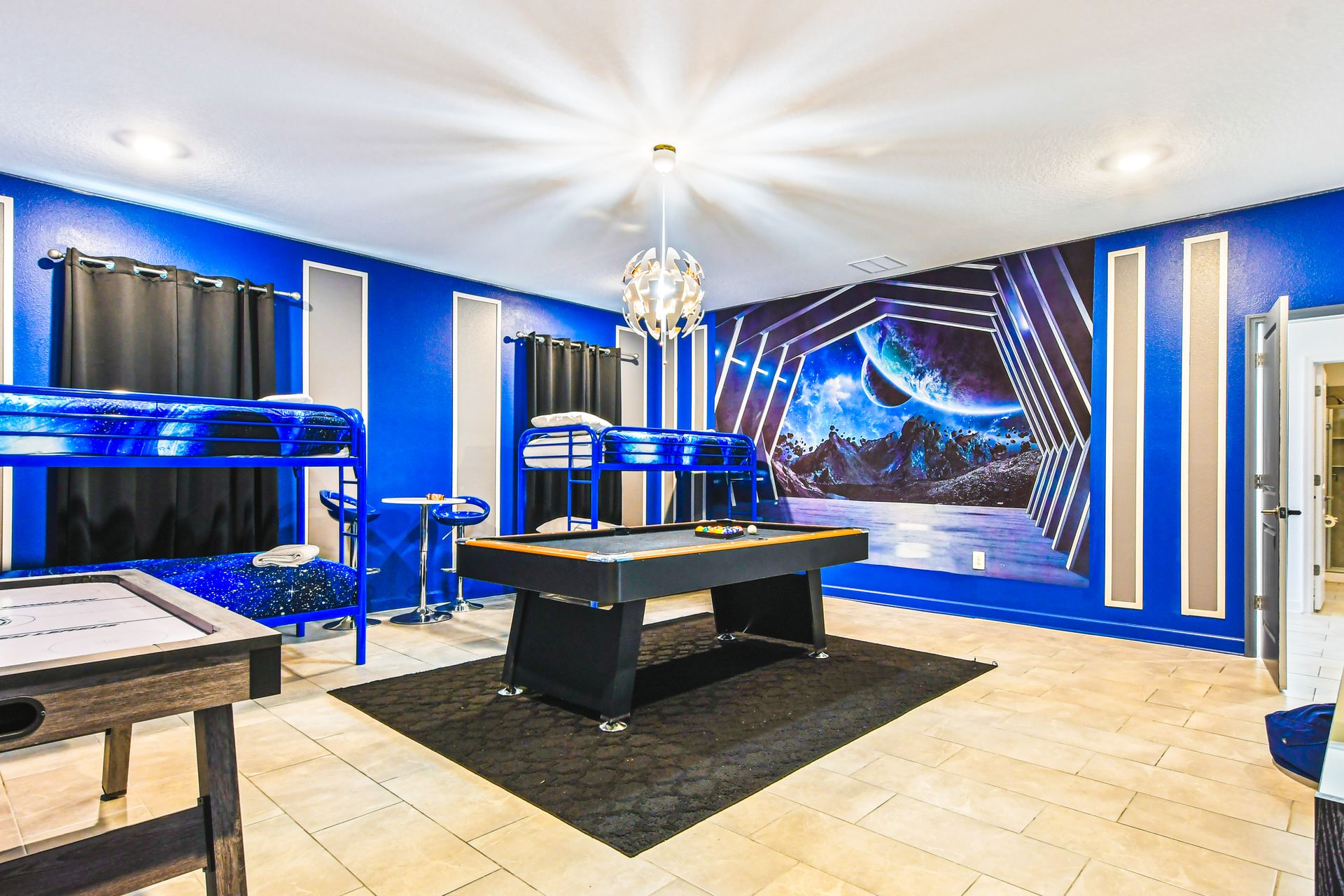 Step into another galaxy! Star Wars-inspired bunk room with games & cosmic décor!