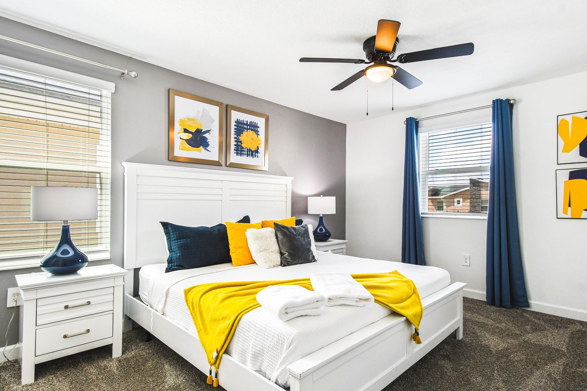 Bright and modern bedroom featuring a white bed frame with bold navy and yellow accents.
