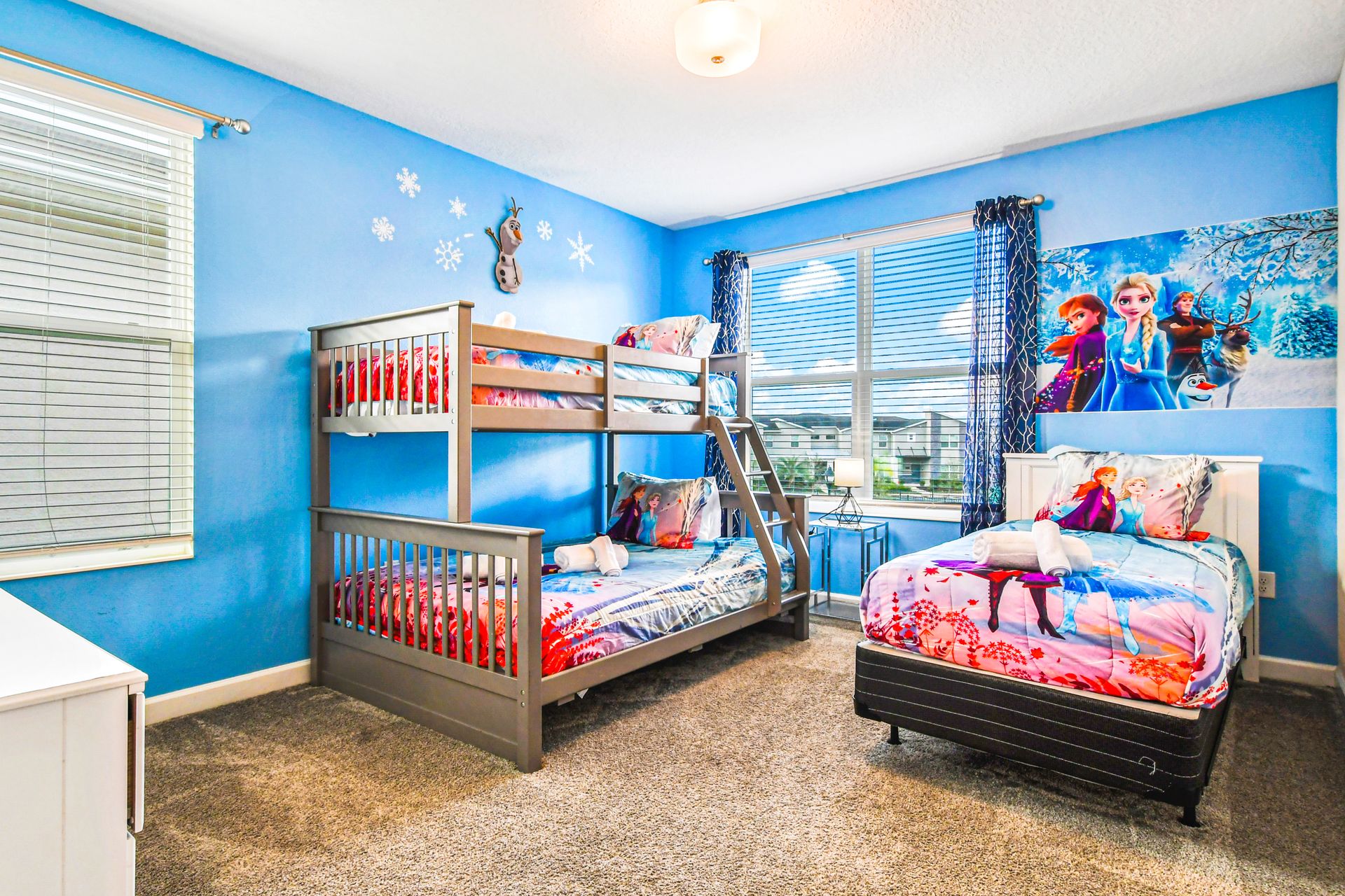 Relax in comfort in our Elsa Inspired room with three beds, offering you a convenient and inviting space to make the most of your stay.