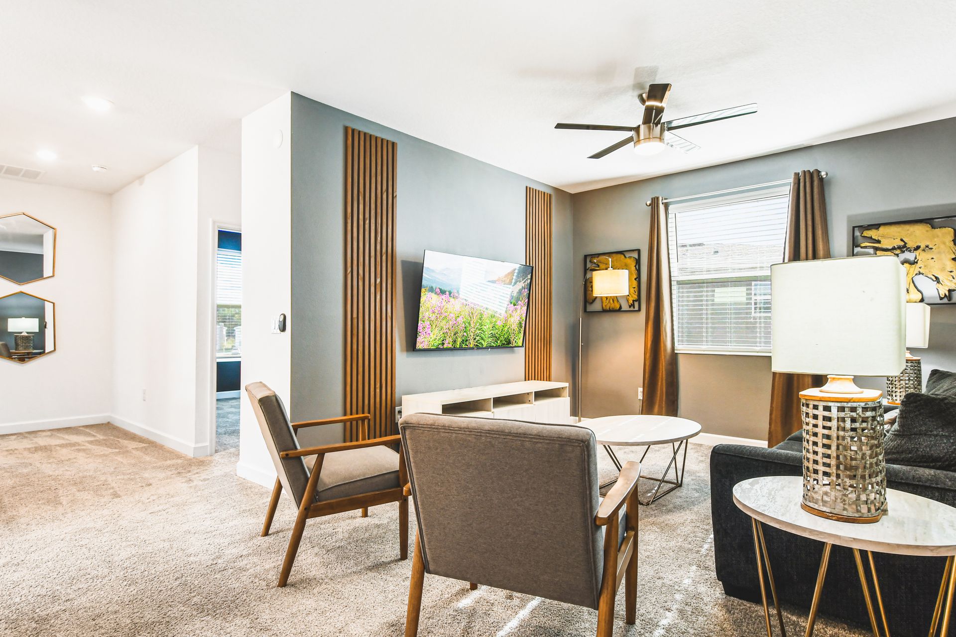 Chic upstairs lounge with smart TV, cozy seating, and modern accent lighting