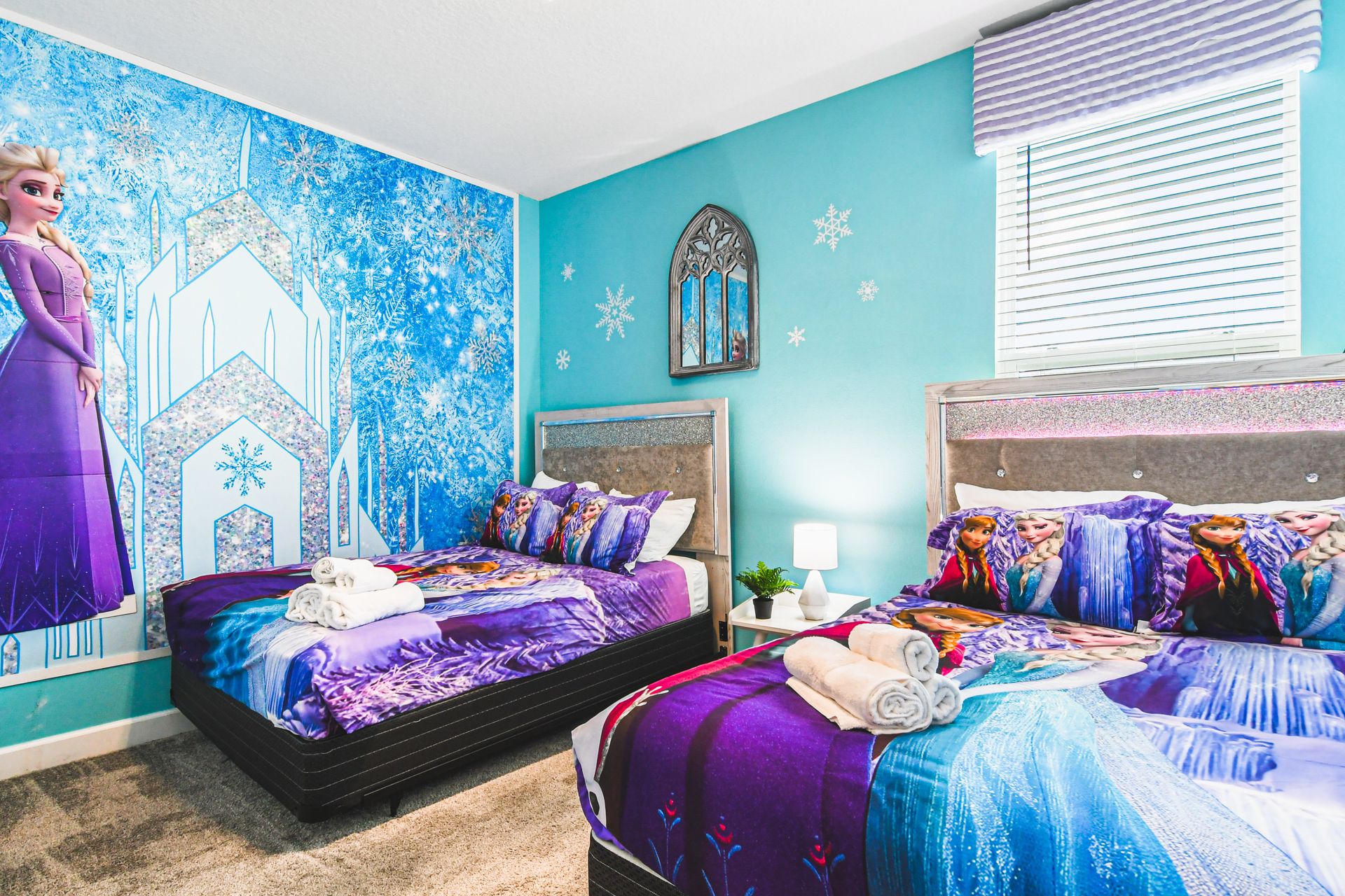Frozen-themed twin room with icy blue walls and magical bedding for little dreamers