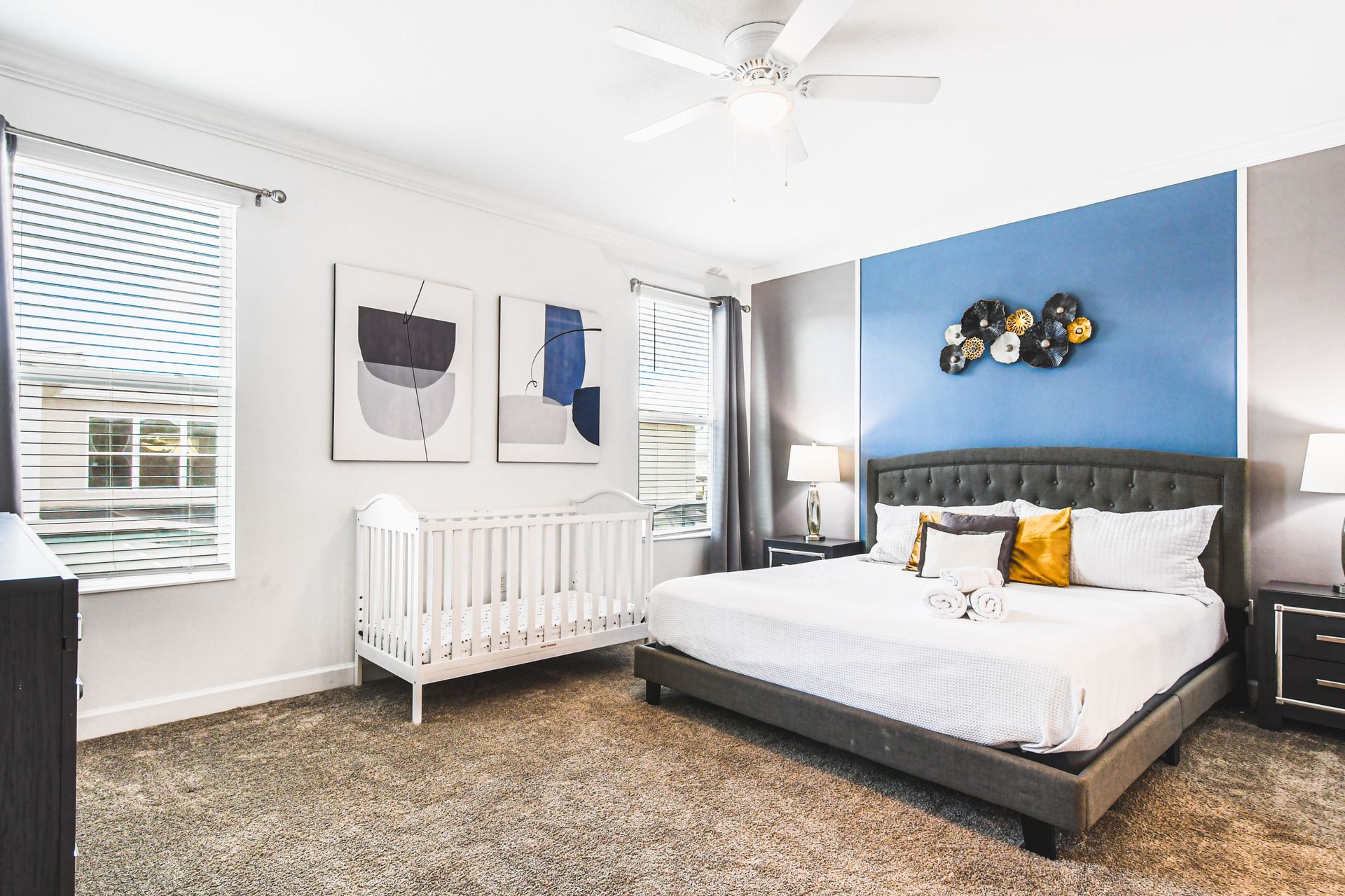 Spacious master suite with king bed, TV, and crib—perfect for families with kids