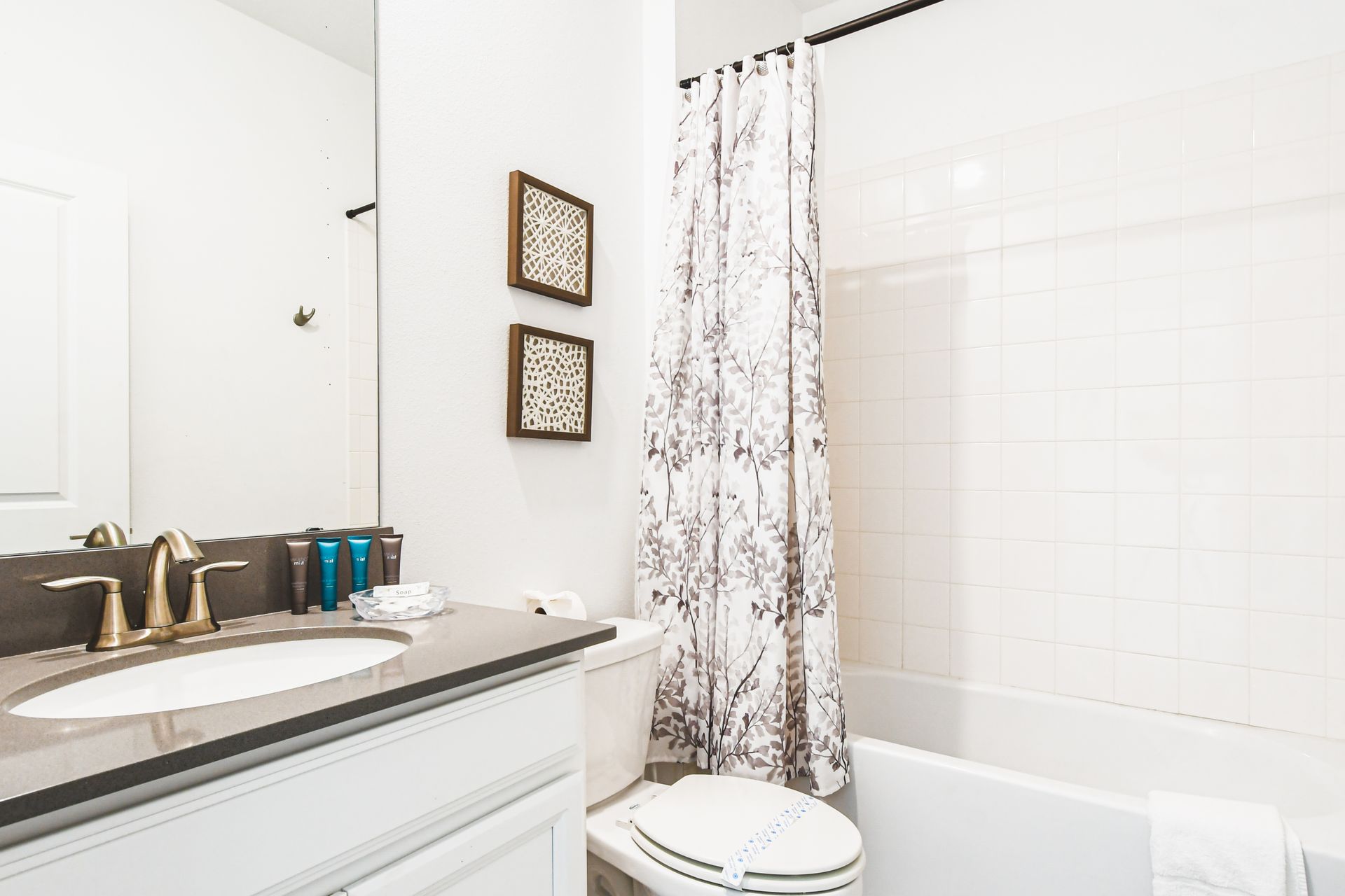 Modern bathroom with double vanity, sleek fixtures, and spacious walk-in shower
