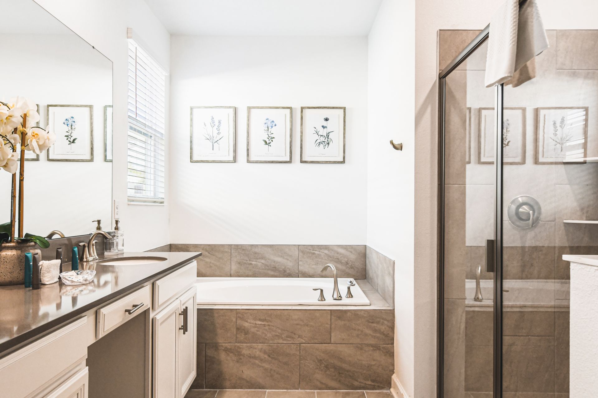 Bright and clean guest bathroom with shower-tub combo and modern vanity touches