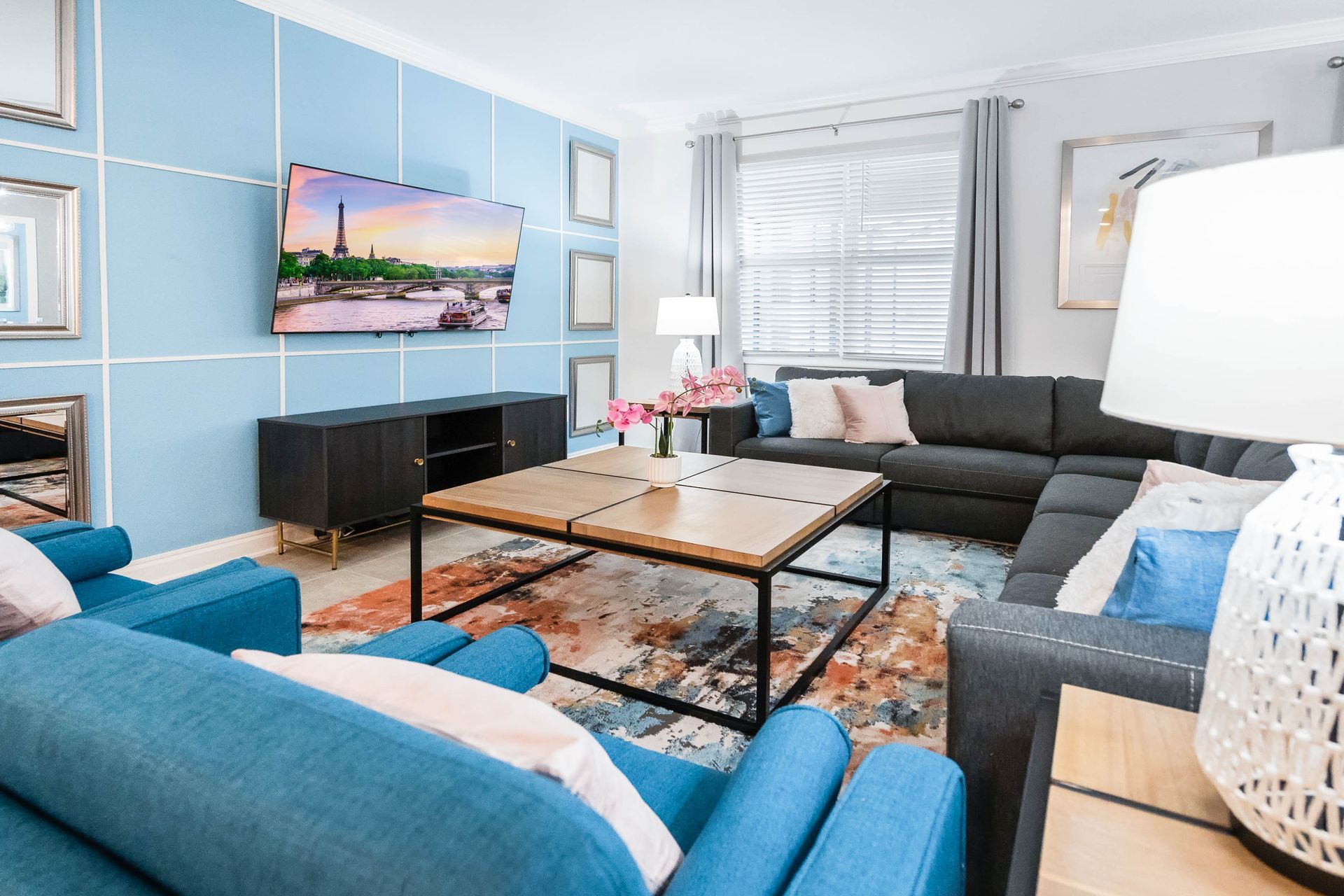 Elegant and cozy living room with a large sectional, smart TV, and stylish decor.