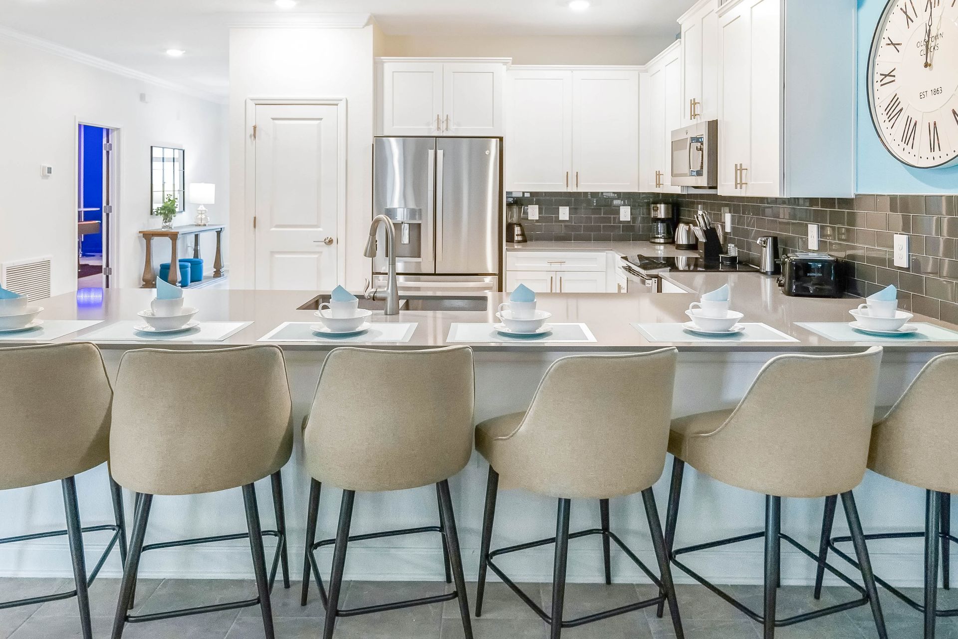 Modern kitchen with sleek island seating for 6, stainless steel appliances, and charm!