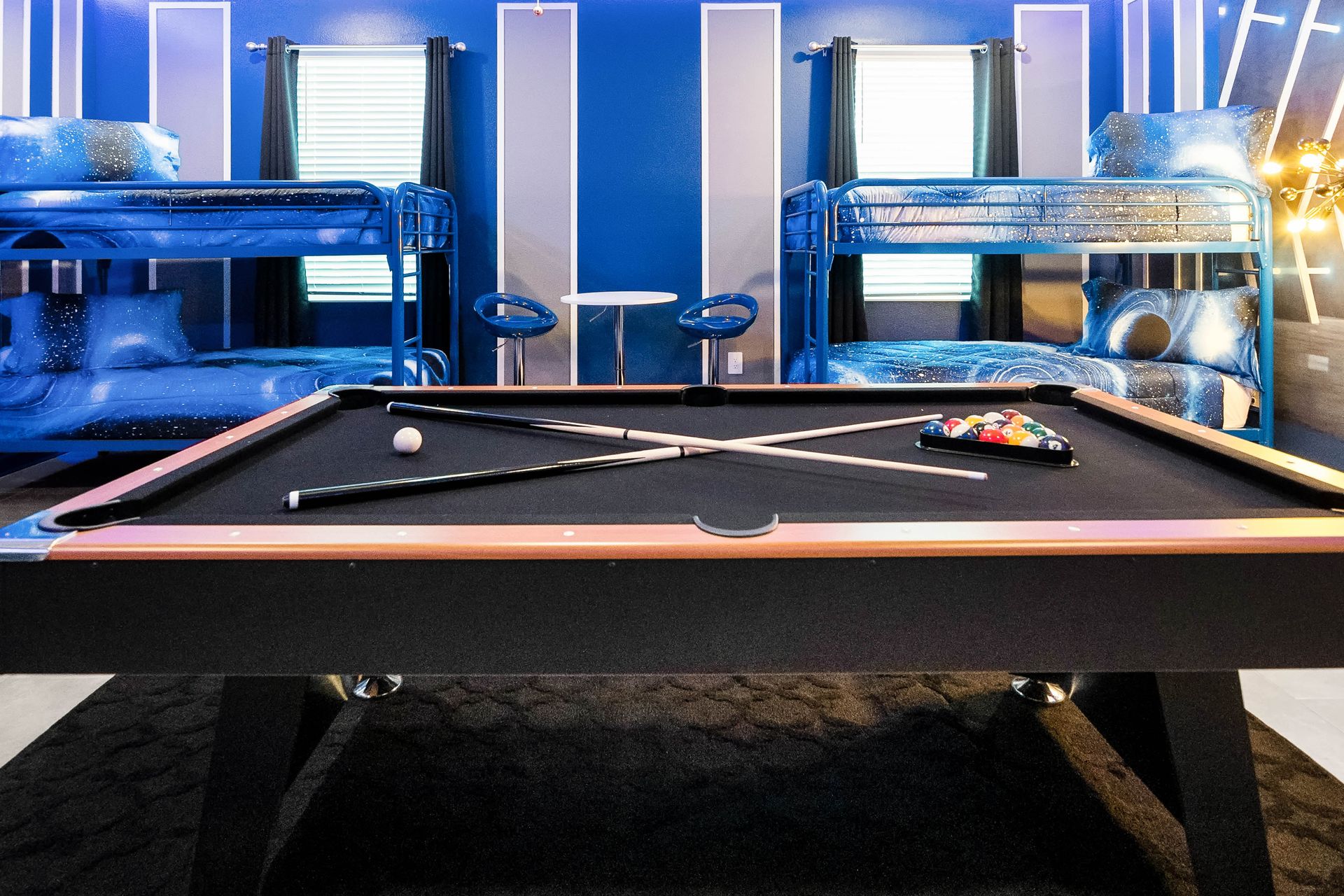 Blast off into fun! Galaxy-themed bunk room with pool table and cosmic vibes!