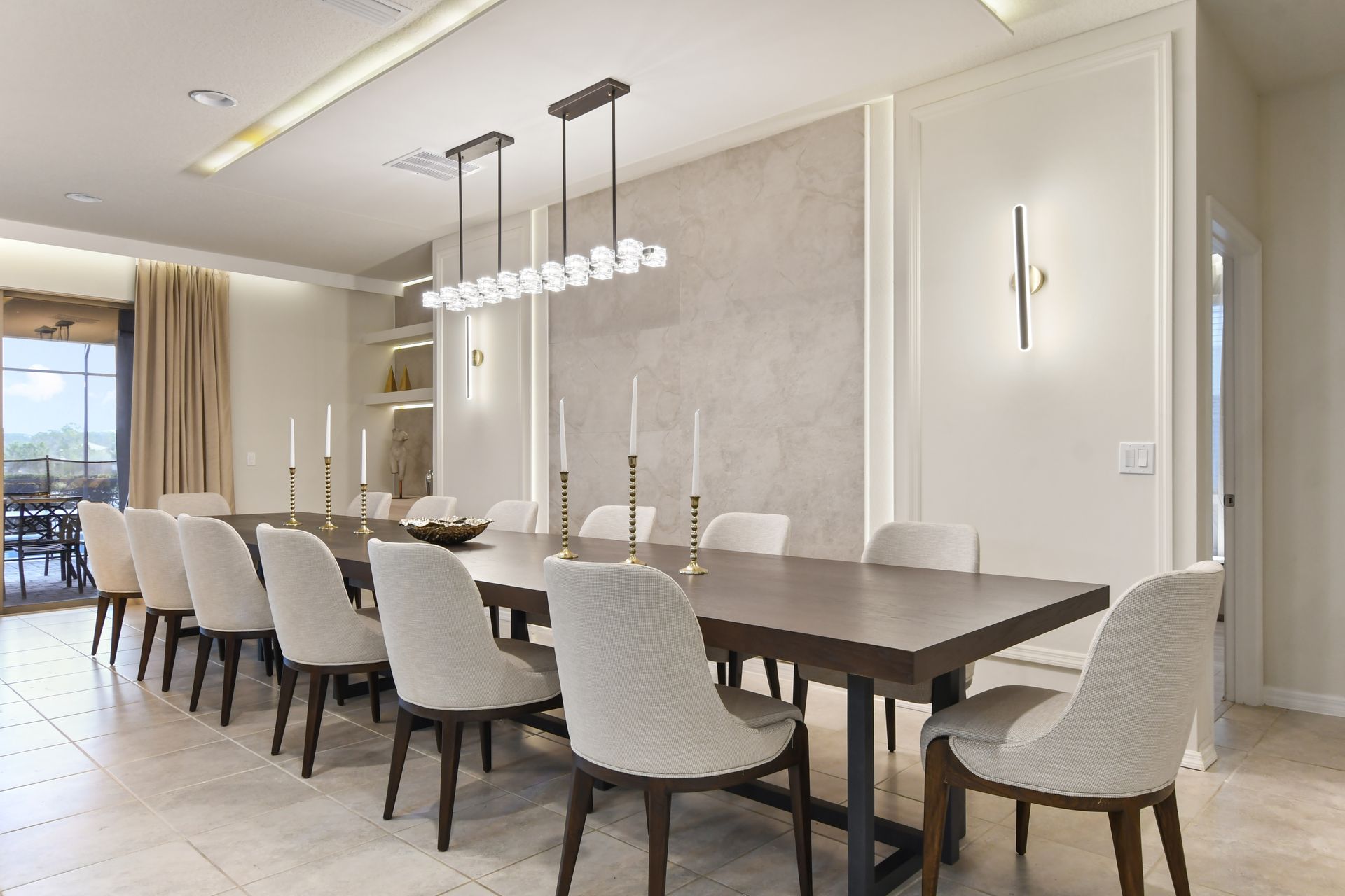 Modern dining room with a sleek wooden table, elegant chairs, and chic lighting.