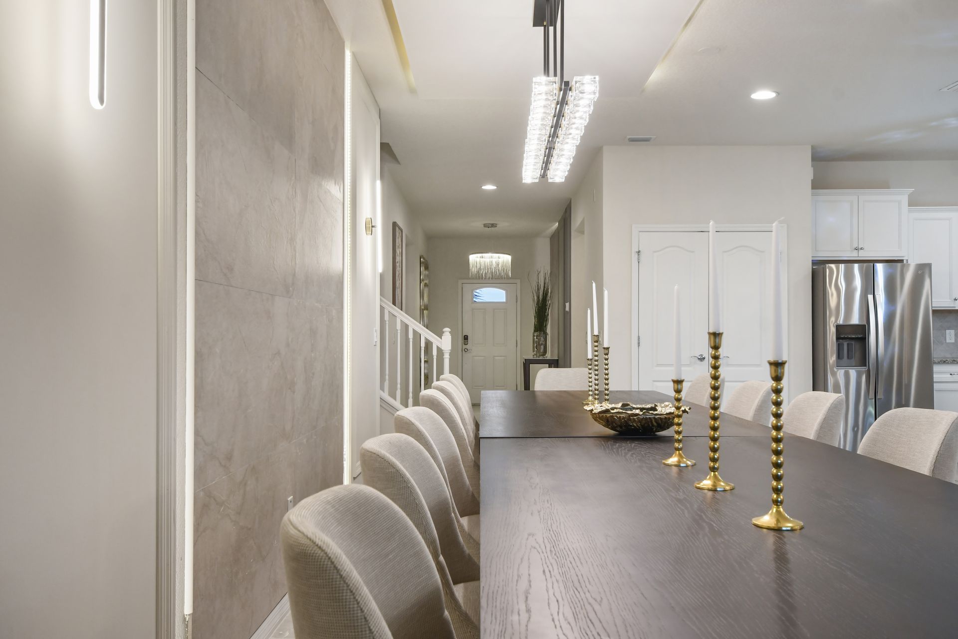 Stylish dining area with modern lighting, sleek decor, and an open layout.