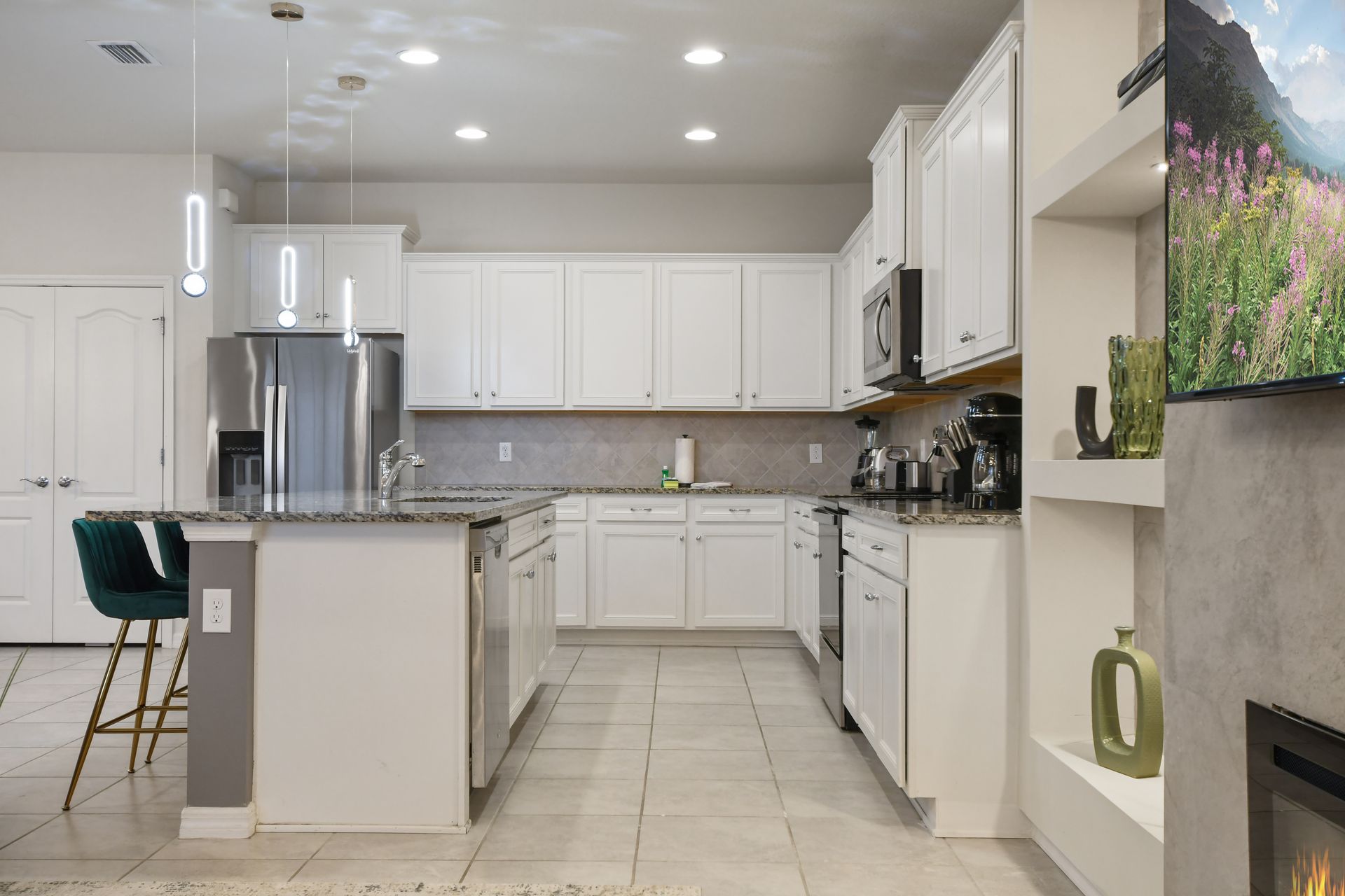Bright and modern kitchen with granite counters, sleek appliances & stylish lighting!
