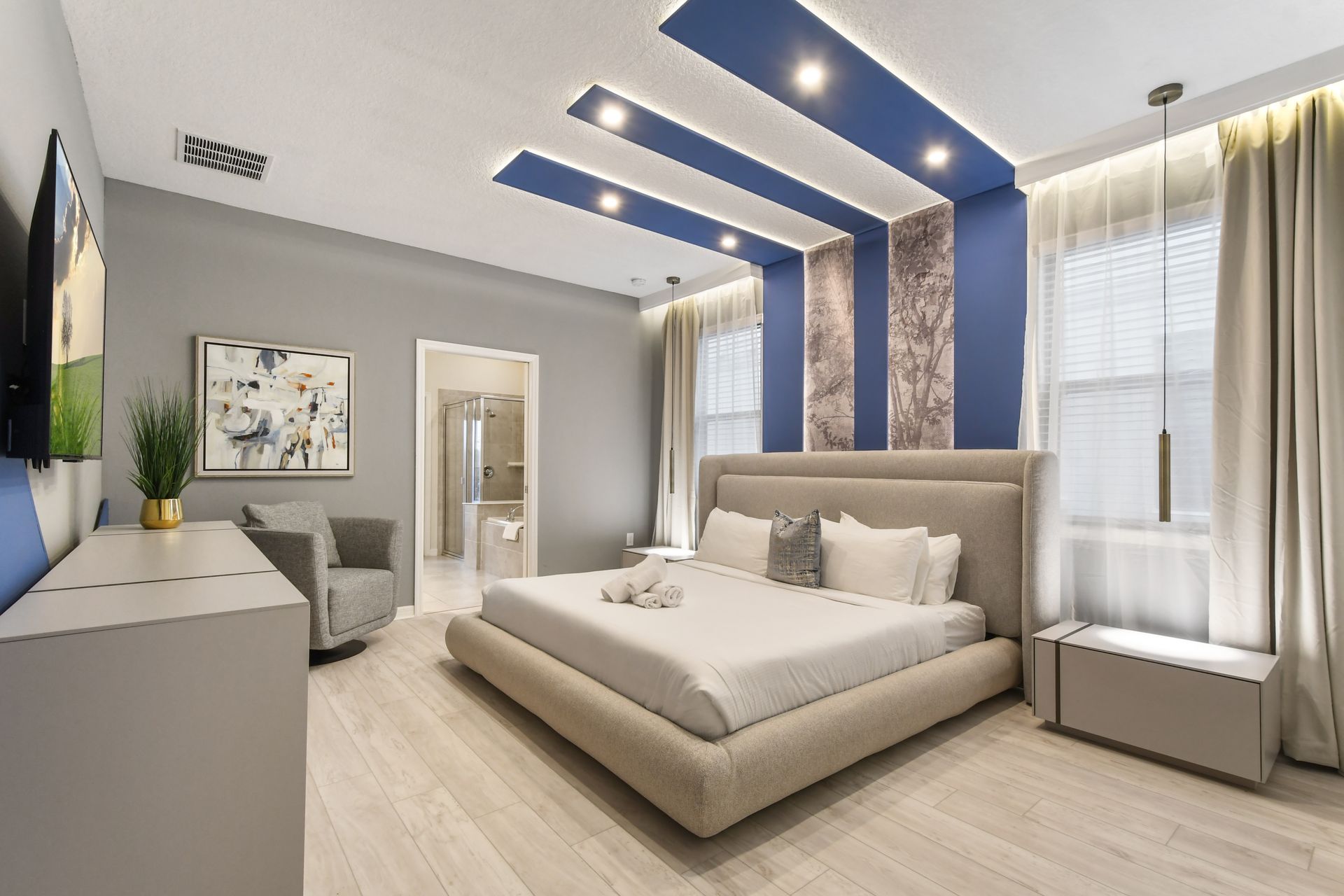 Modern master suite with a plush king bed, spa-like bath & stylish ambiance!