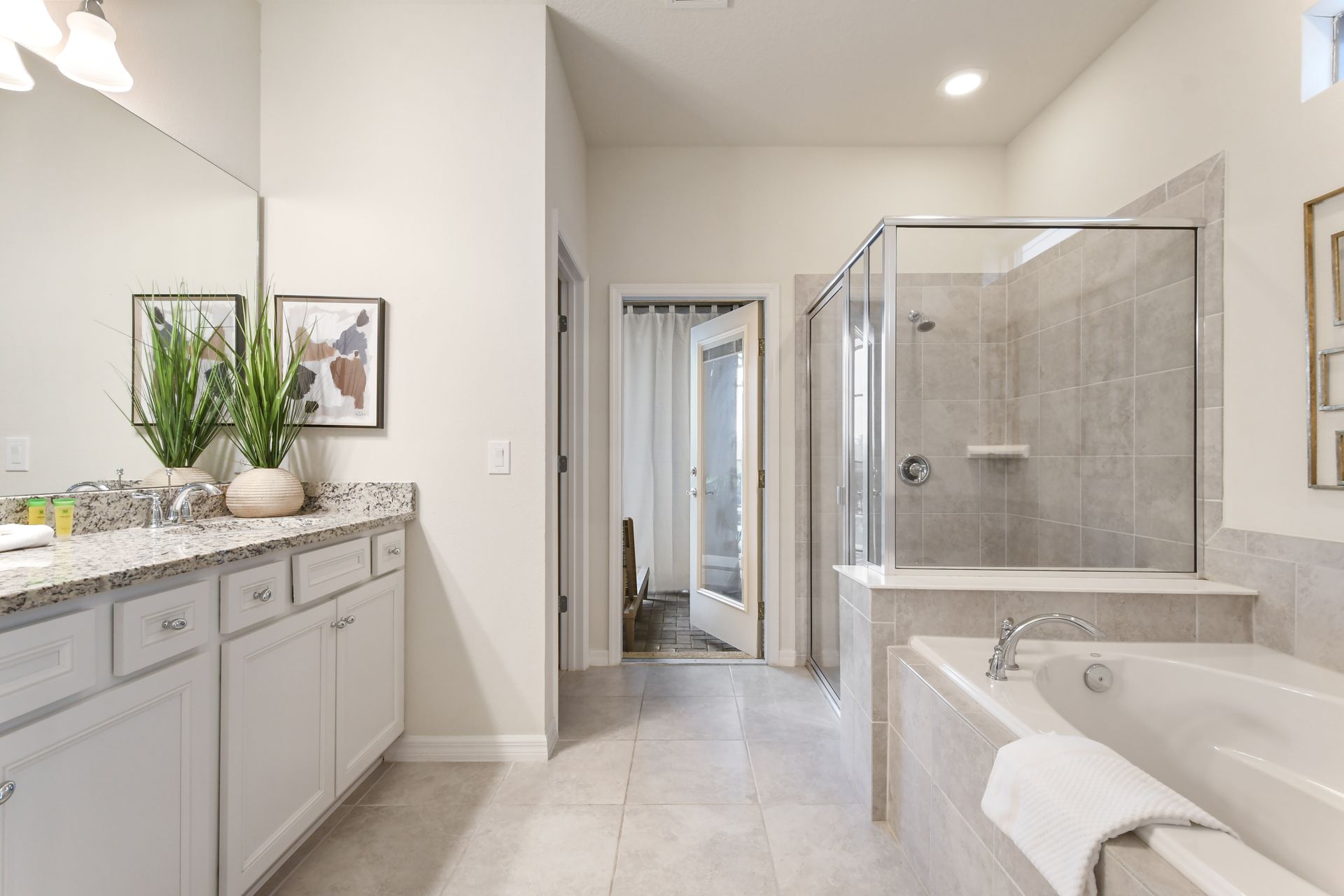 Elegant spa-like bathroom with a soaking tub, walk-in shower & direct pool access!