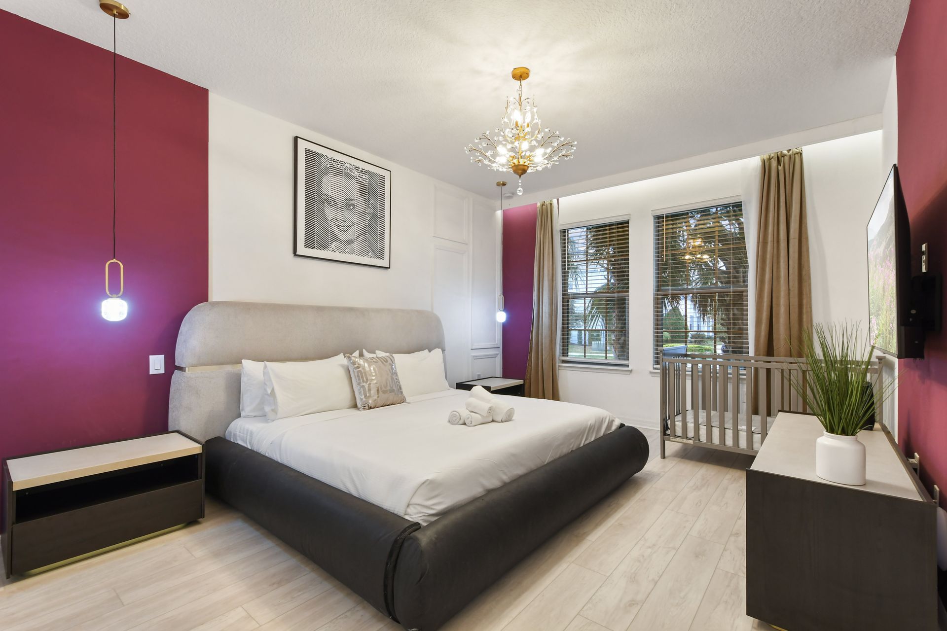 Elegant master suite with luxe décor, plush king bed & a cozy crib for little ones!