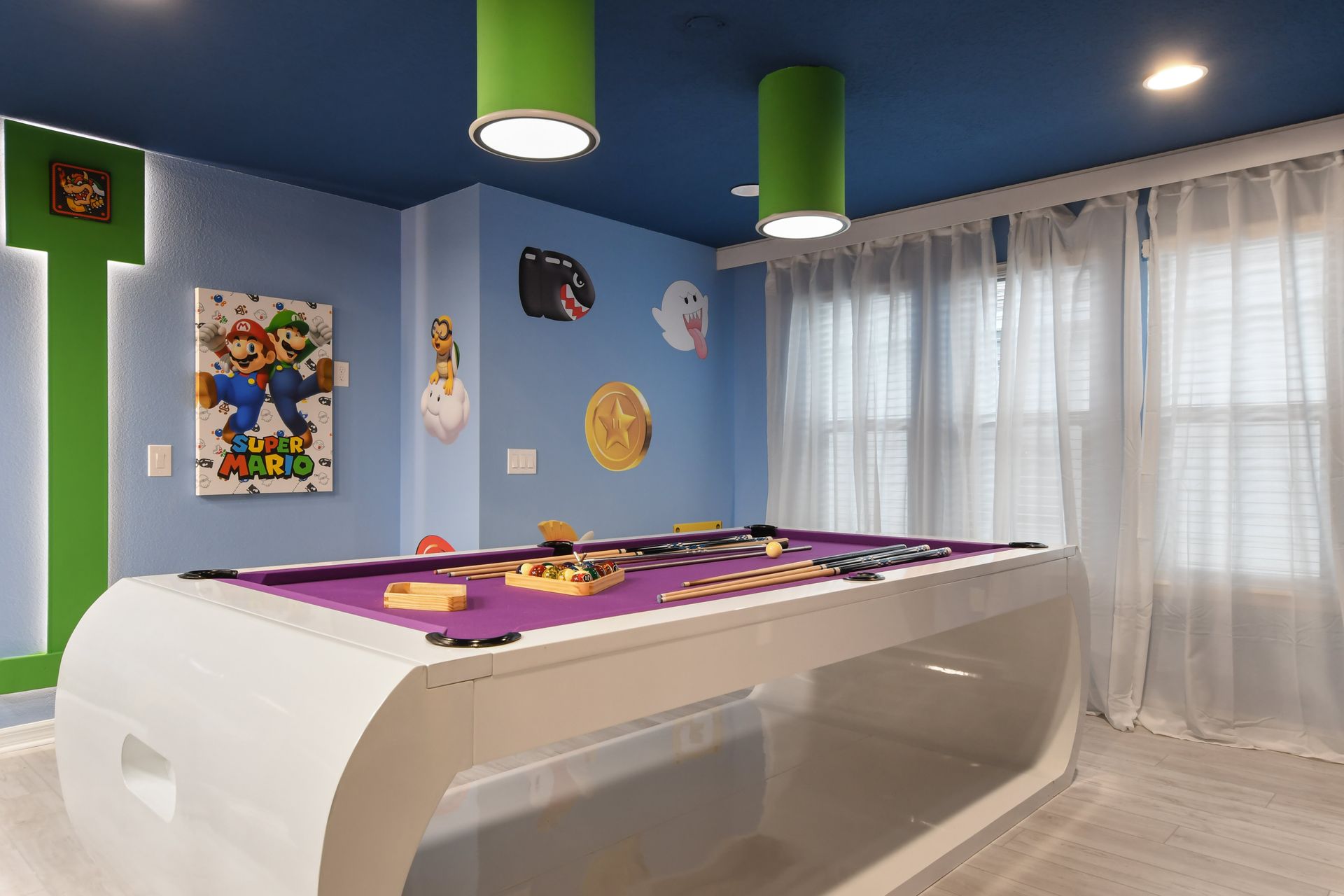 Super Mario-themed game room with a sleek pool table & arcade fun!