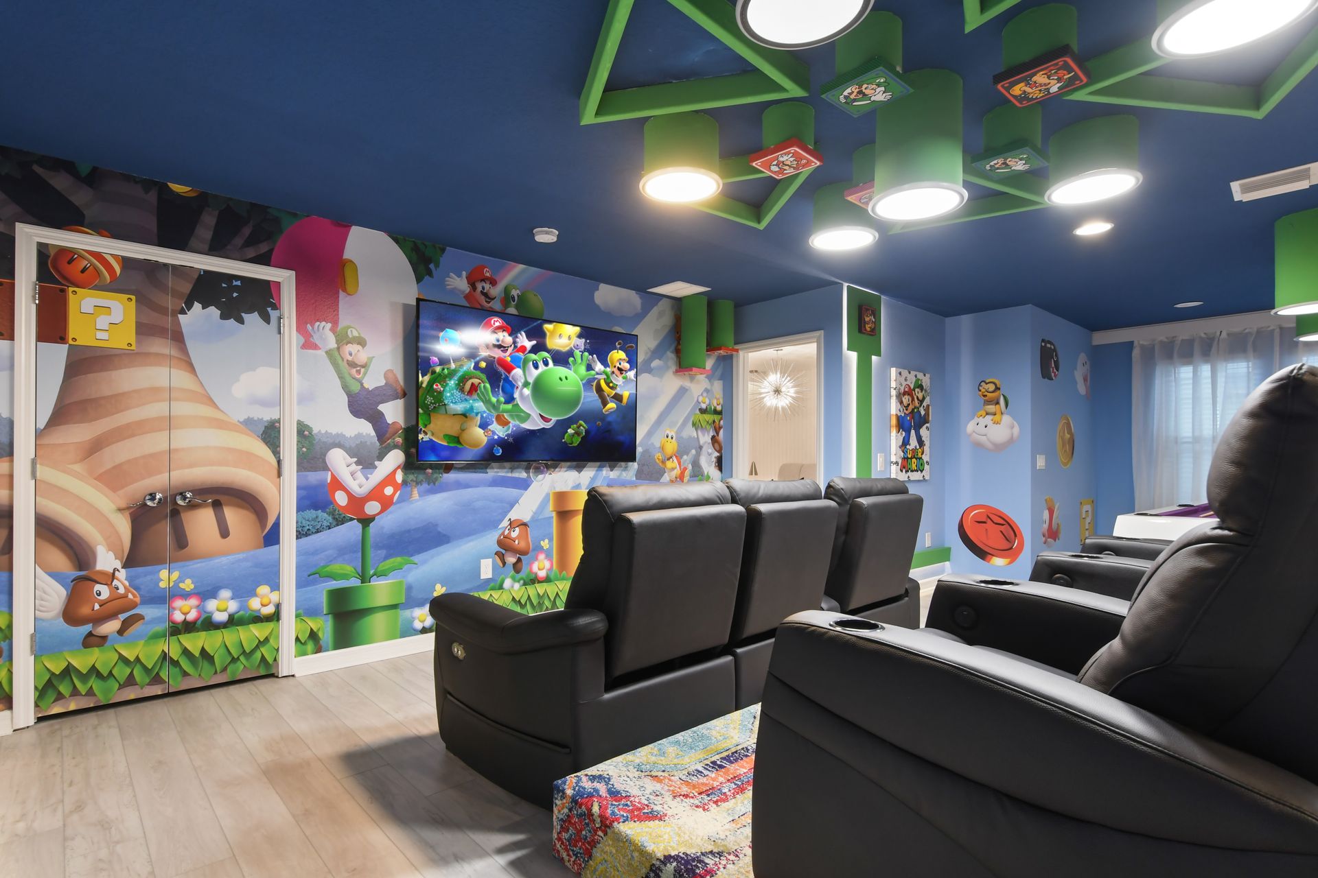 Mario-themed entertainment room with theater seating, vibrant wall art, and gaming.
