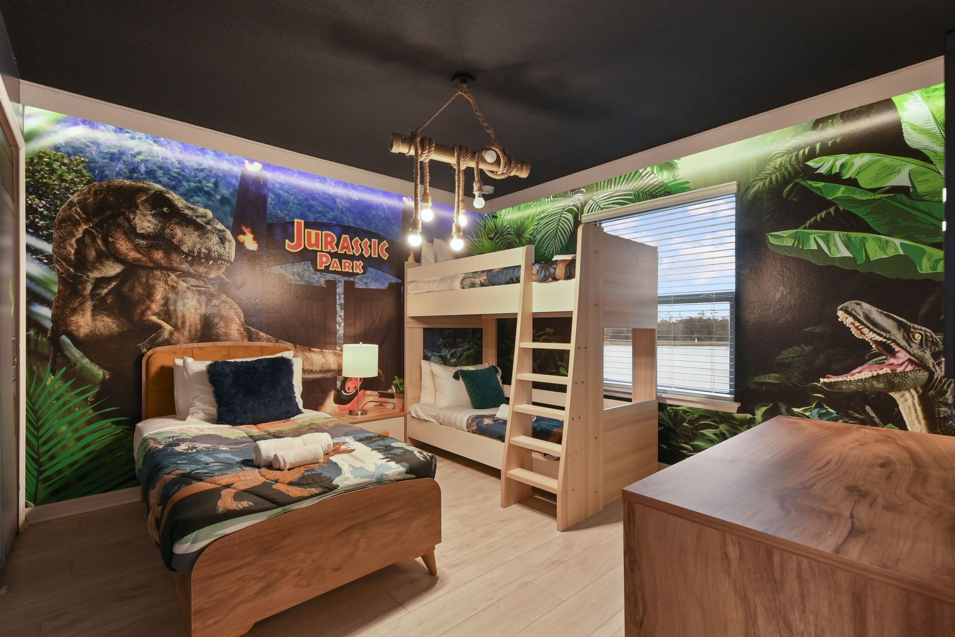 Step into a Jurassic adventure! Dino-themed room with cozy beds & jungle vibes!
