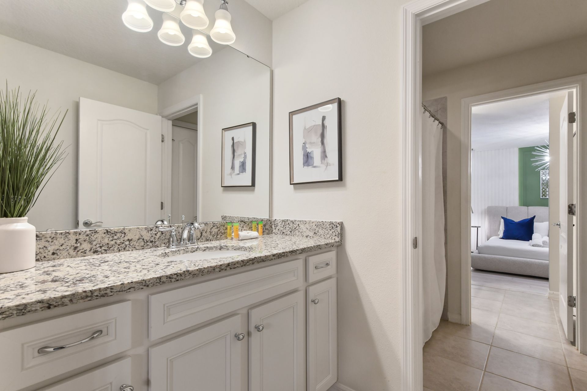 Elegant bathroom with dual sinks, granite counters, walk-in shower & pool access!