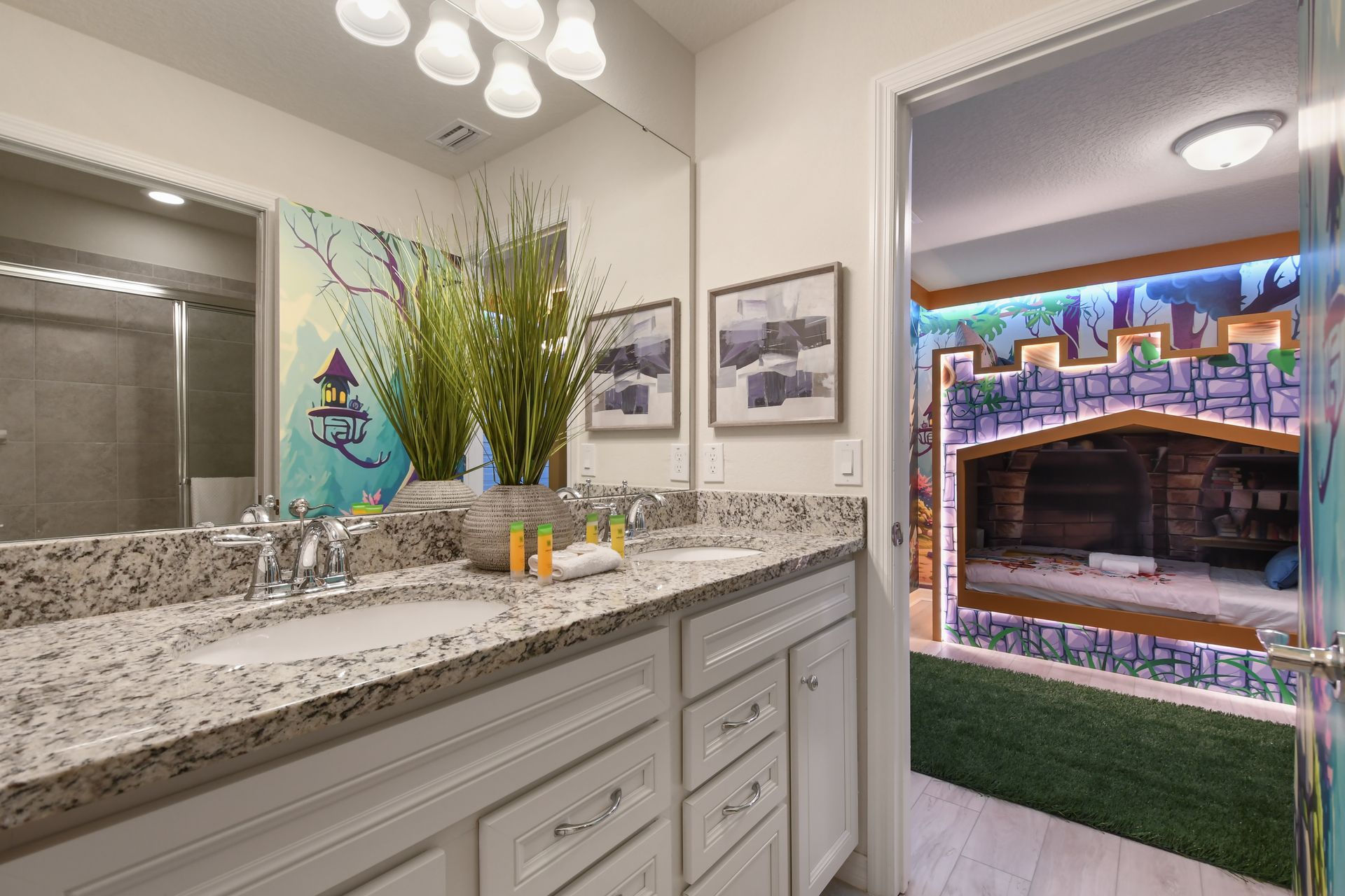 Elegant bathroom with dual sinks, granite counters, walk-in shower & pool access!