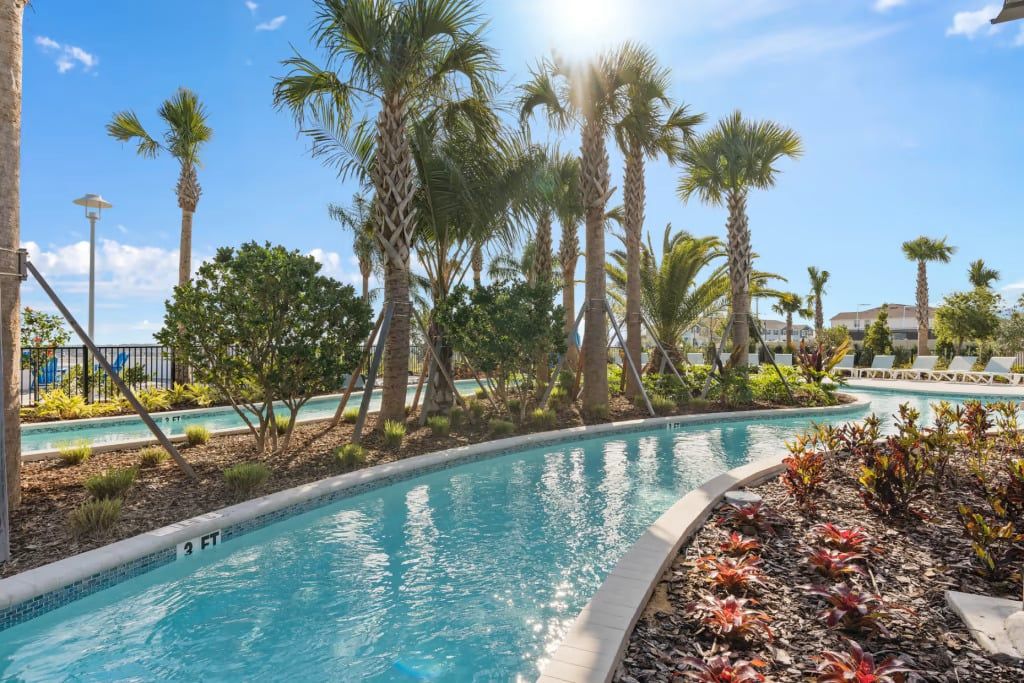 Tropical lazy river surrounded by palms—perfect for a relaxing resort day in the sun