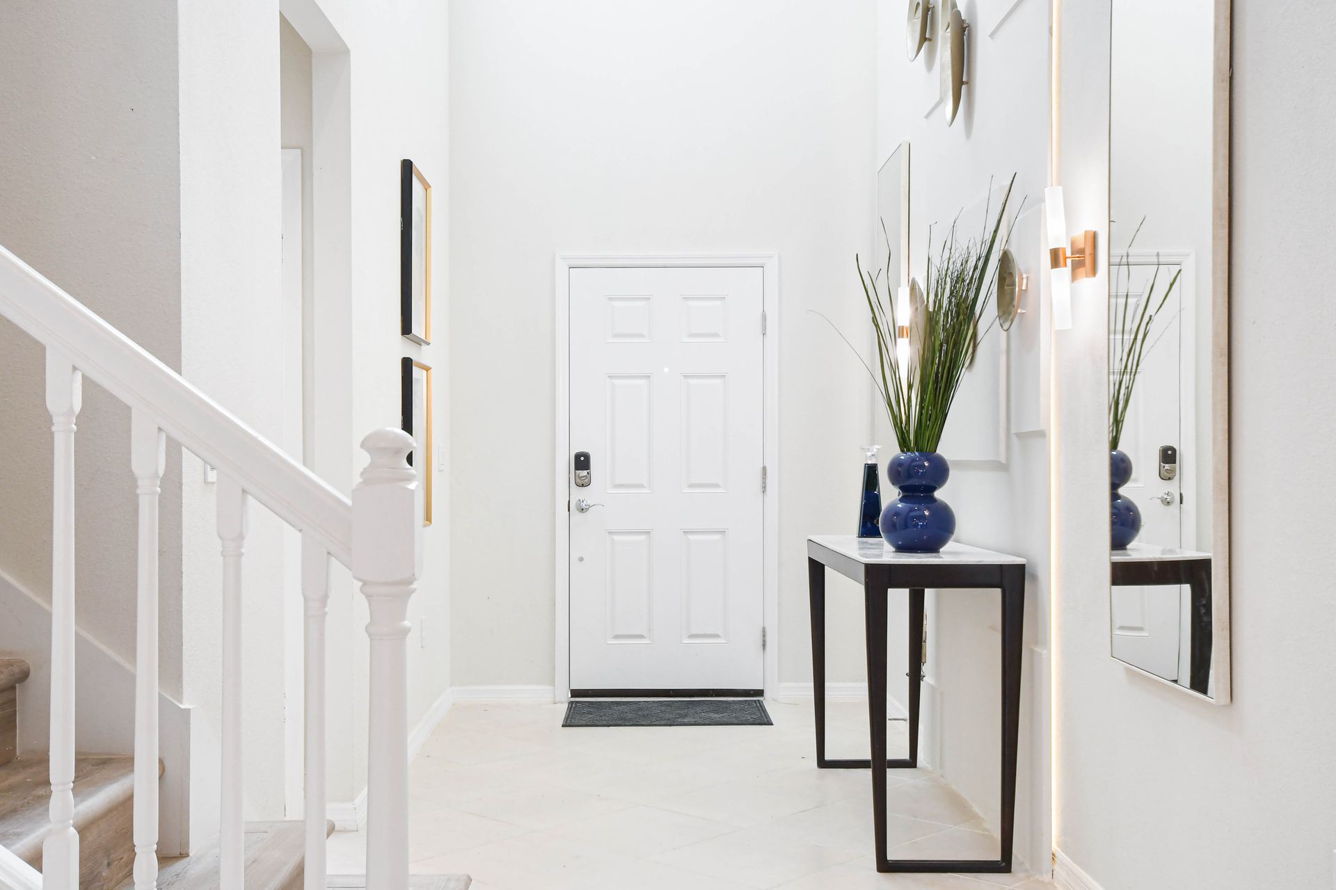 Bright and modern entryway with sleek decor, statement mirror, and stylish accents