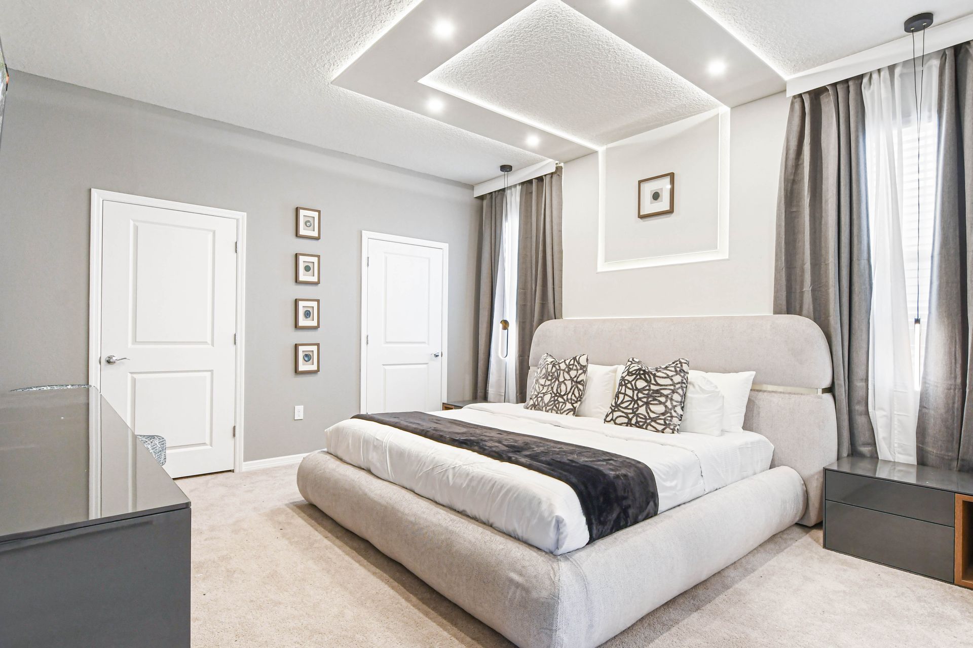 Serene modern bedroom with plush king bed, ambient lighting, and elegant decor