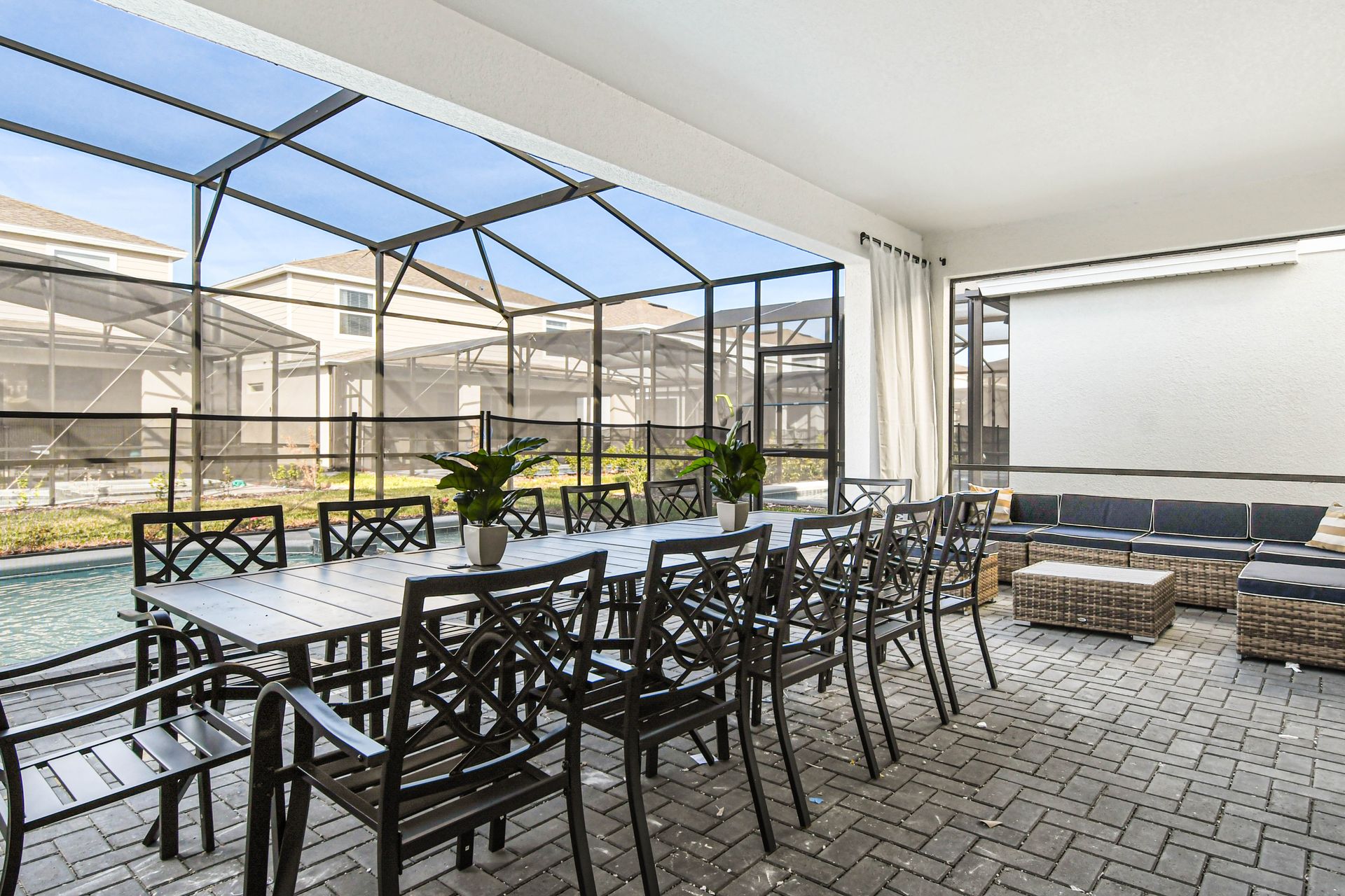 Covered patio with dining for twelve, poolside lounge, and screened-in comfort