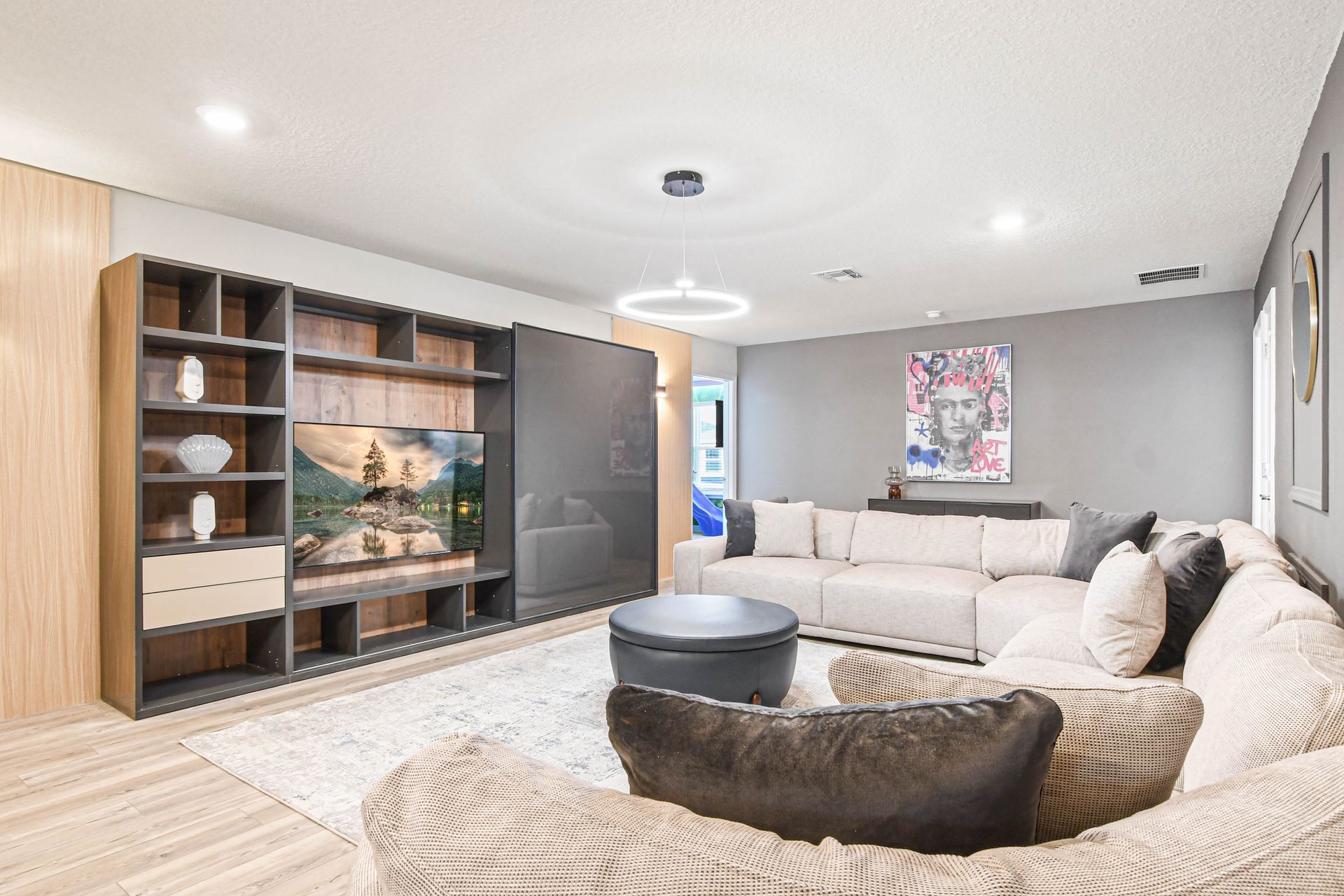 Cozy entertainment room with sleek TV wall, modern décor, and spacious seating