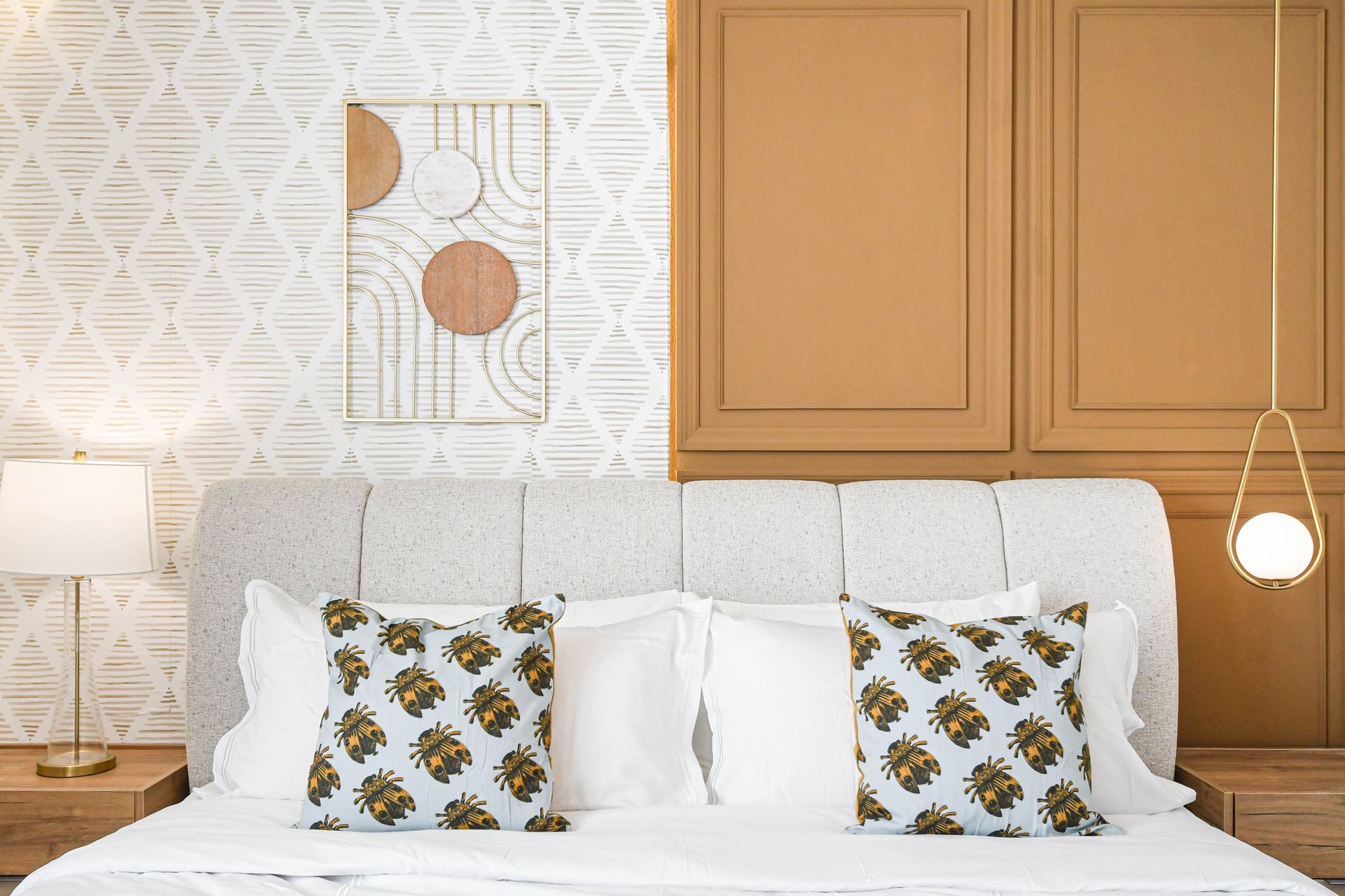 Modern boho bedroom with luxe finishes, warm tones, and designer lighting