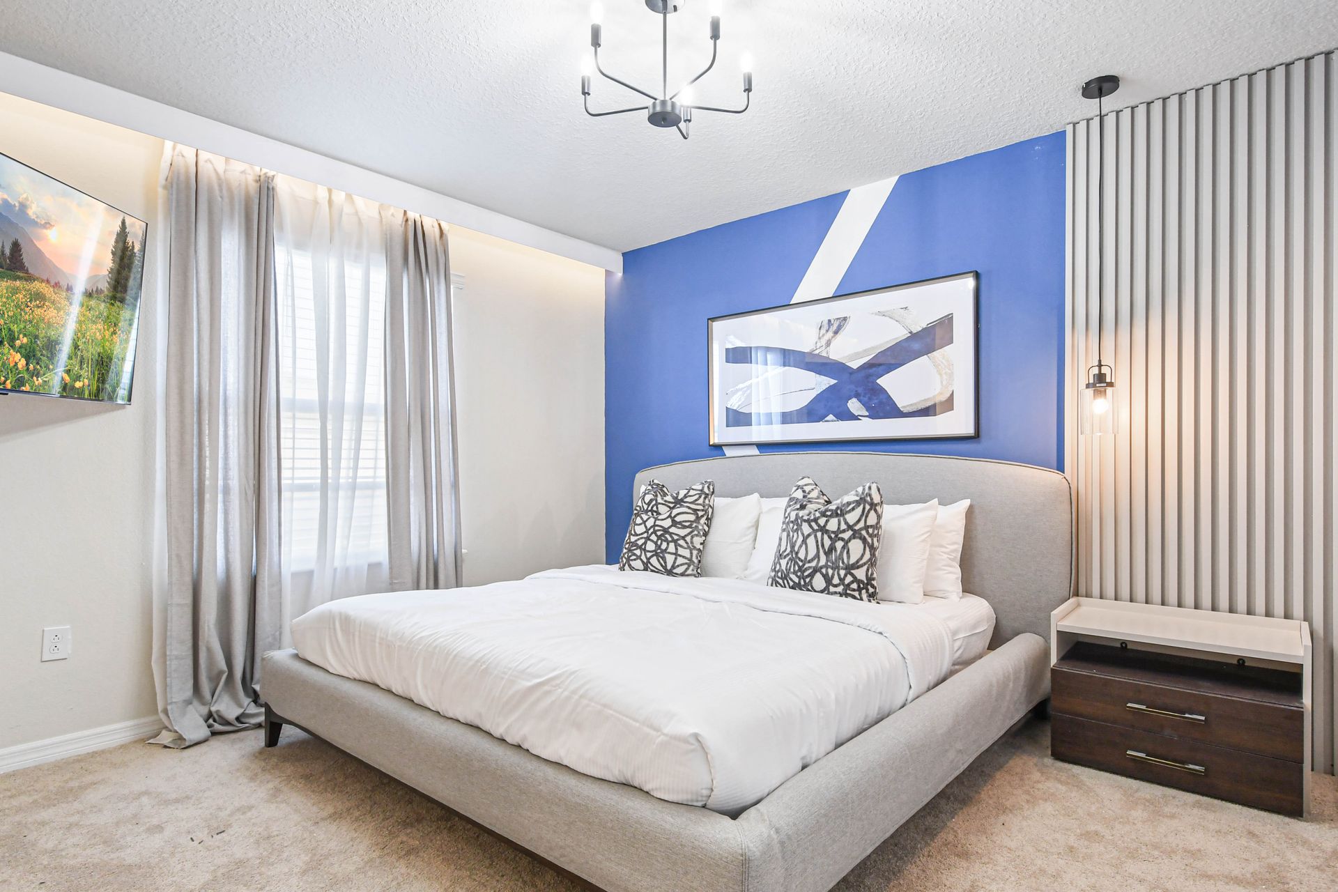 Bold and modern king bedroom with abstract art, accent wall, and cozy vibes