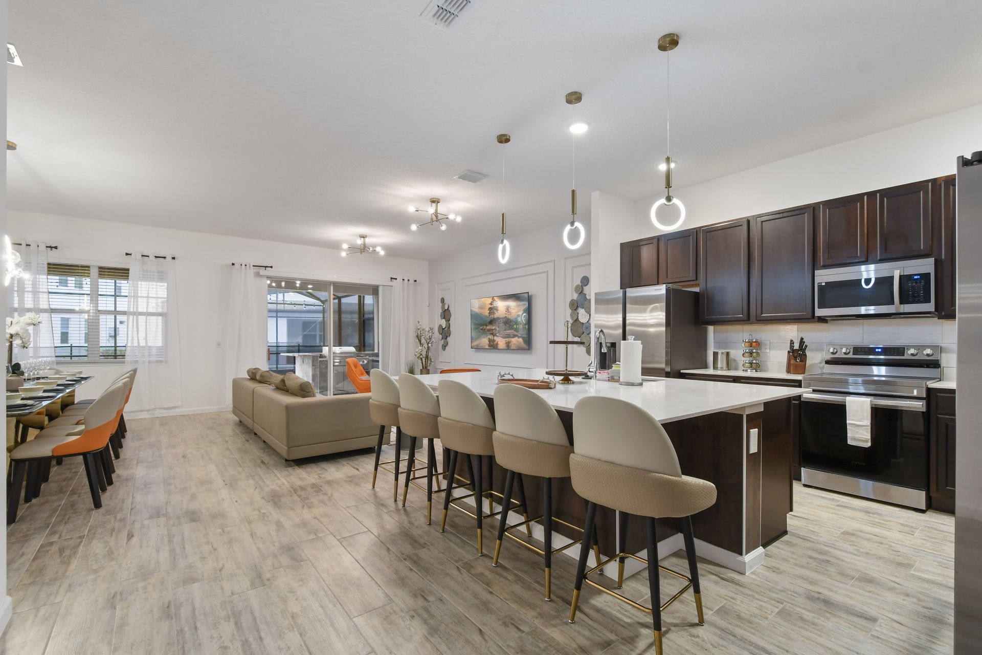 Spacious open-concept kitchen and living area with modern decor and elegant lighting.