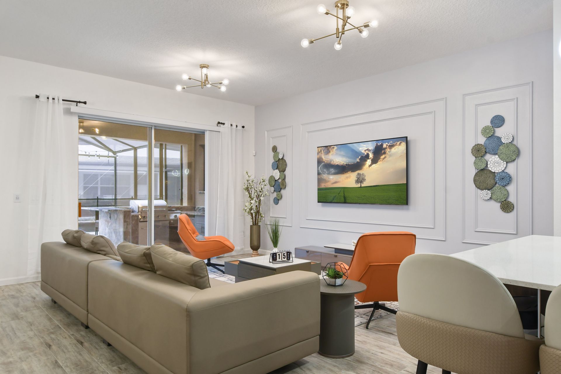 Stylish living room with modern decor, cozy seating, and a large smart TV.