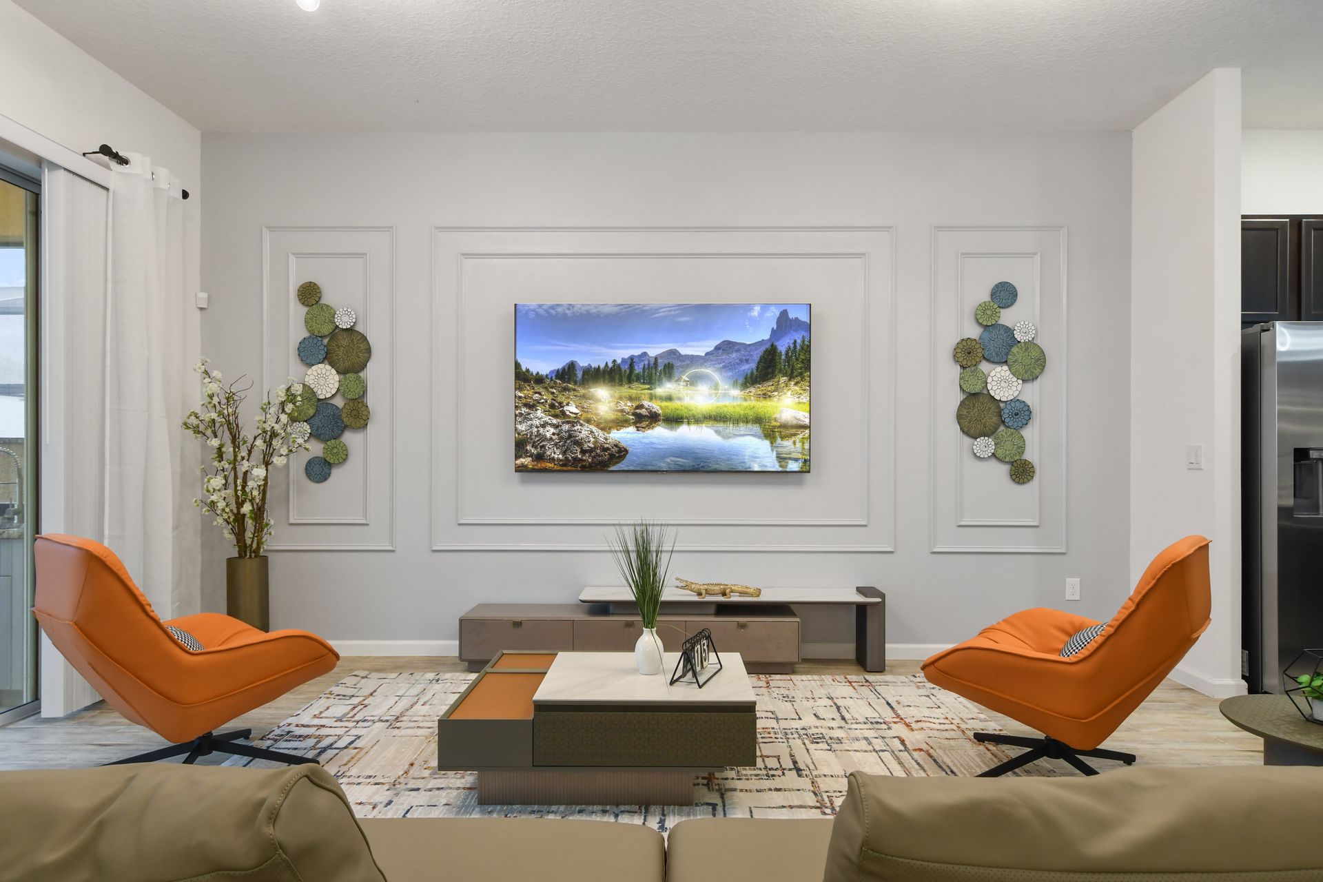 Modern living room with sleek decor, vibrant accents, and a large smart TV.