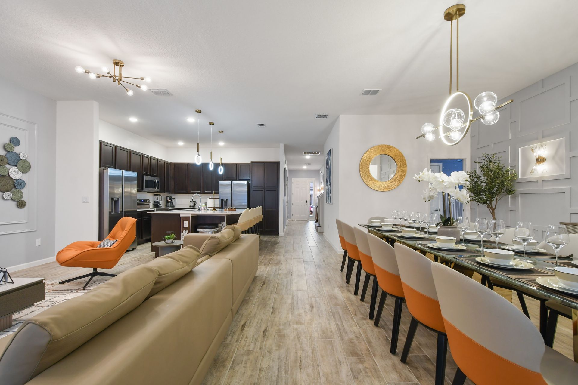 Spacious open-concept living area with a modern kitchen, elegant dining, and cozy seating.