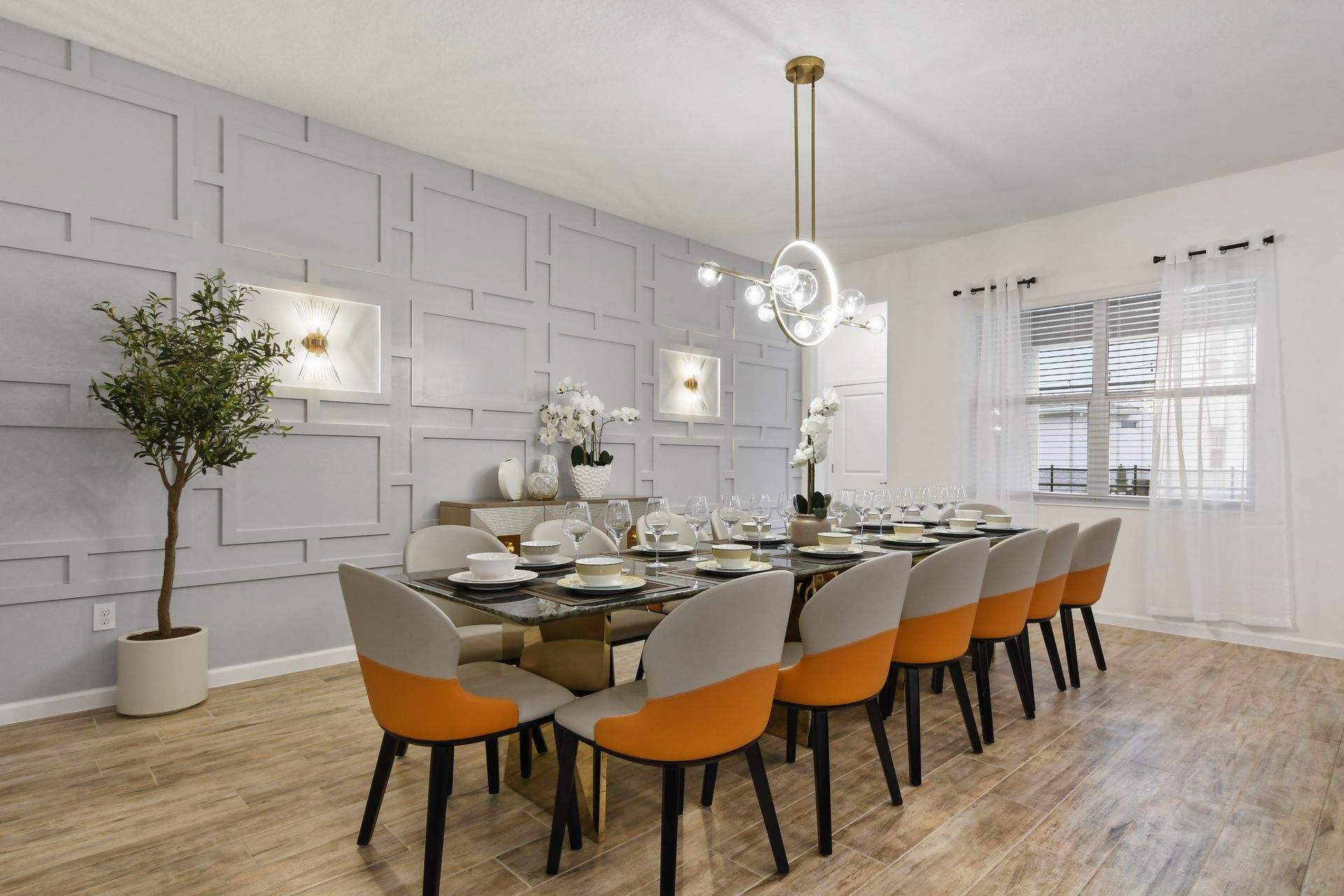 Elegant dining room with modern decor, seating for twelve, and sophisticated lighting.