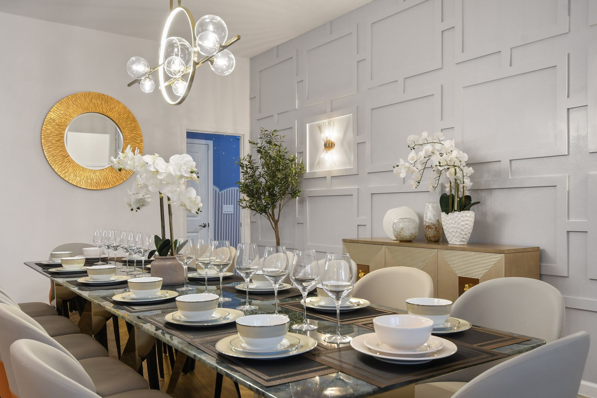 Sophisticated dining room with elegant table settings, modern decor, and stylish lighting.