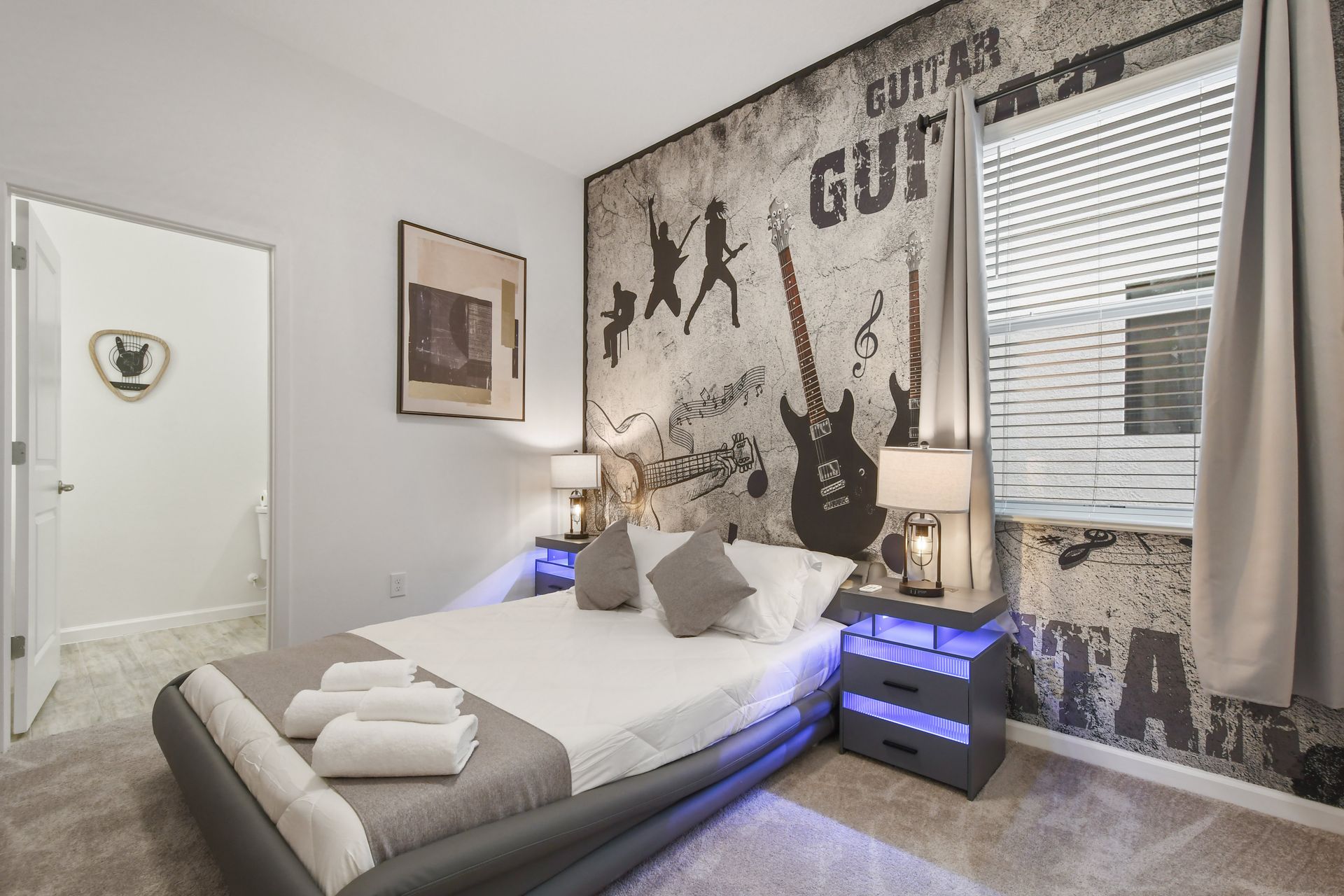 Rock-themed bedroom with stylish decor, LED-lit nightstands, and a cozy modern bed.