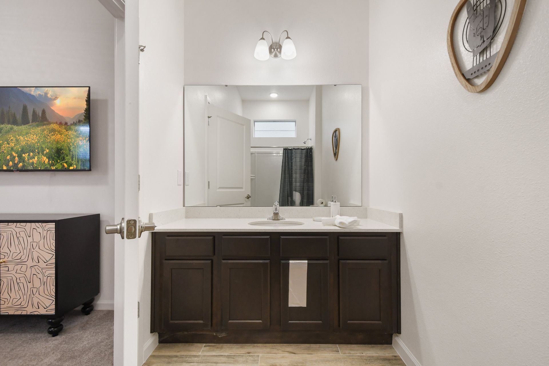 Modern bathroom with sleek vanity, bright lighting & a refreshing walk-in shower!
