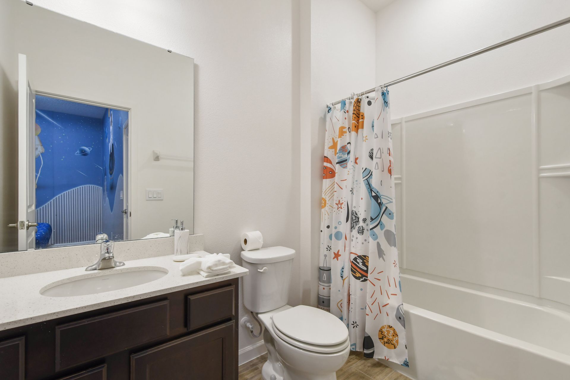 Bathroom with modern vanity, bright lighting, and a relaxing tub!
